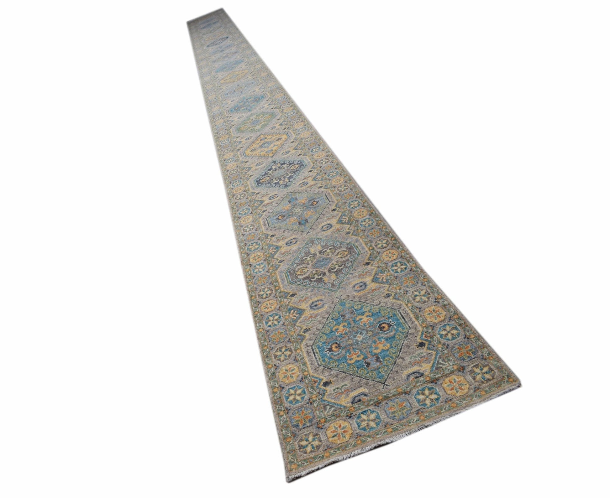 A long, handmade Afghan Chobi runner rug featuring traditional geometric patterns in muted tones.