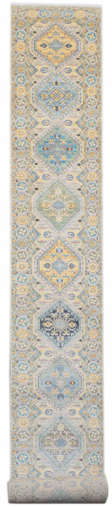 An Afghan Chobi runner rug featuring a series of geometric diamond medallions in soft earth tones.