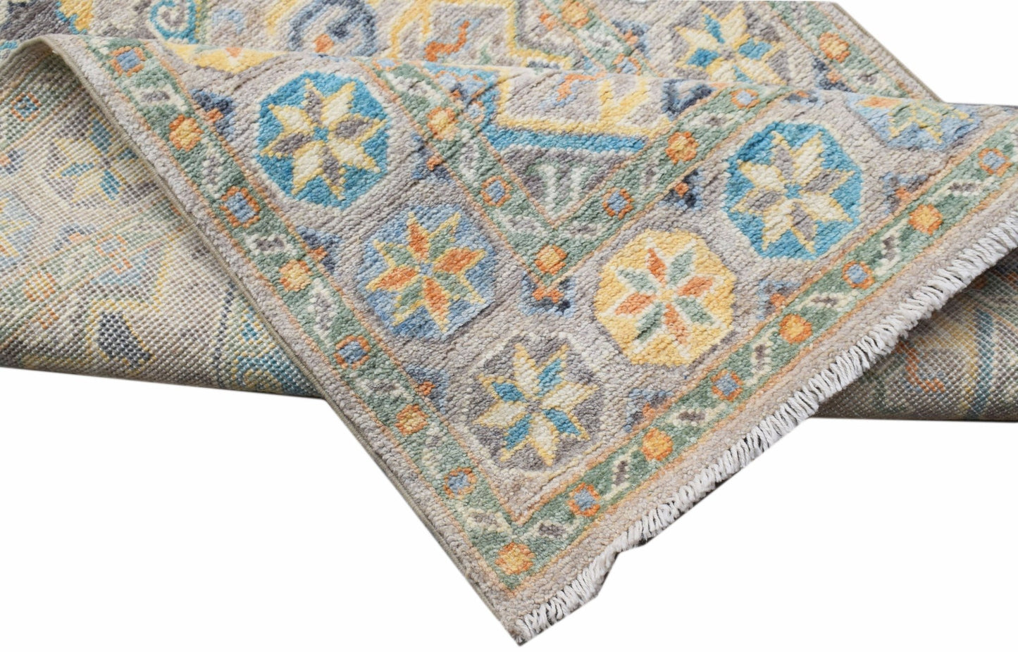 An Afghan Chobi runner with a traditional geometric pattern in blue, yellow, and orange tones.