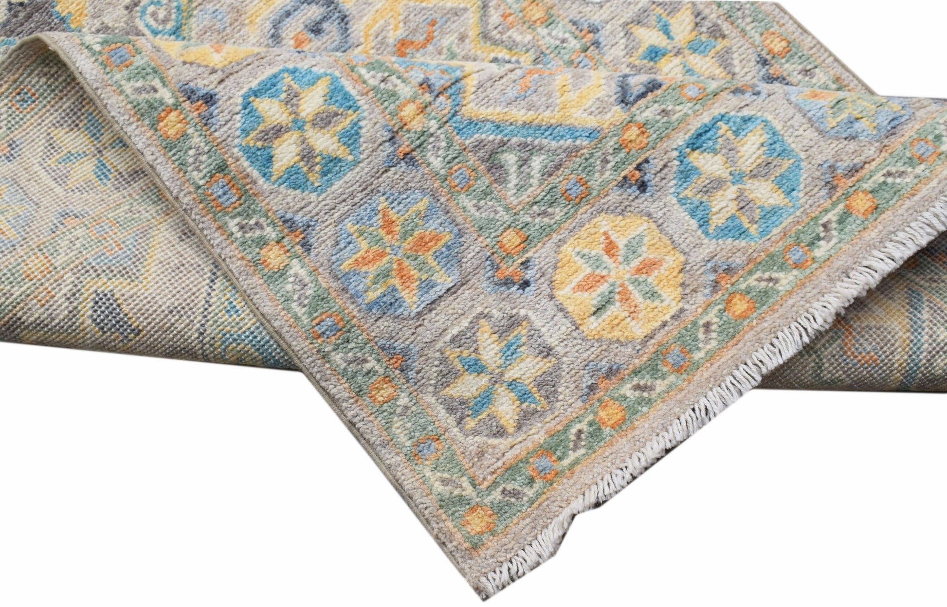 An Afghan Chobi runner with a traditional geometric pattern in blue, yellow, and orange tones.