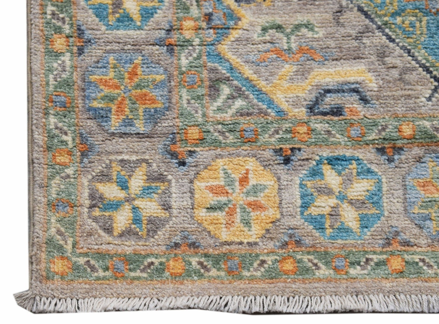 A handwoven Afghan Chobi runner featuring a geometric floral pattern in muted earth tones.