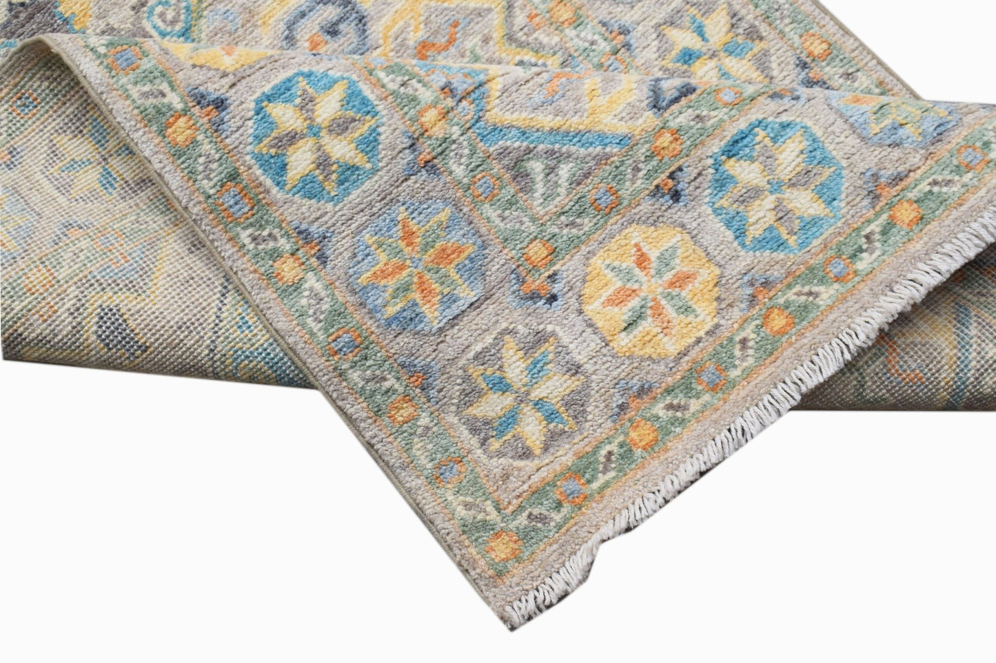 A handwoven Afghan Chobi runner featuring a geometric floral pattern in blue, yellow, and orange.