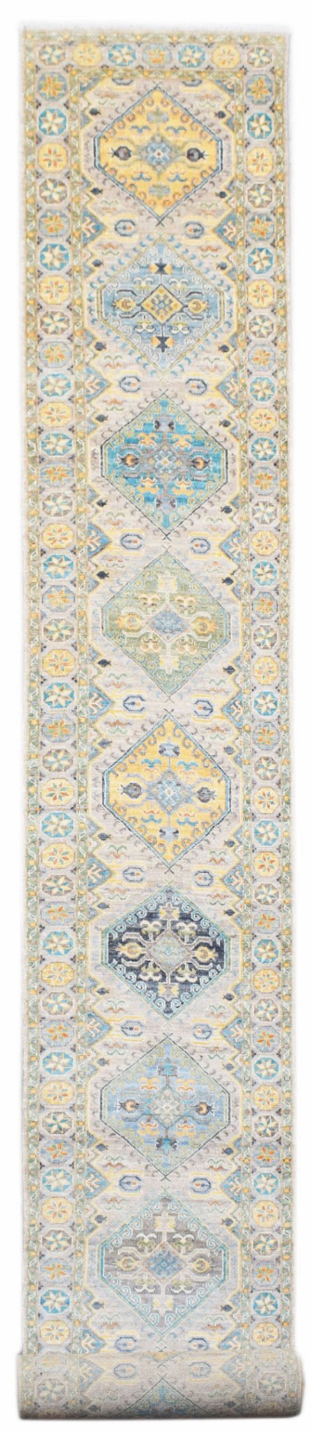 A long, handwoven Afghan Chobi runner rug featuring a series of colorful geometric diamond motifs.