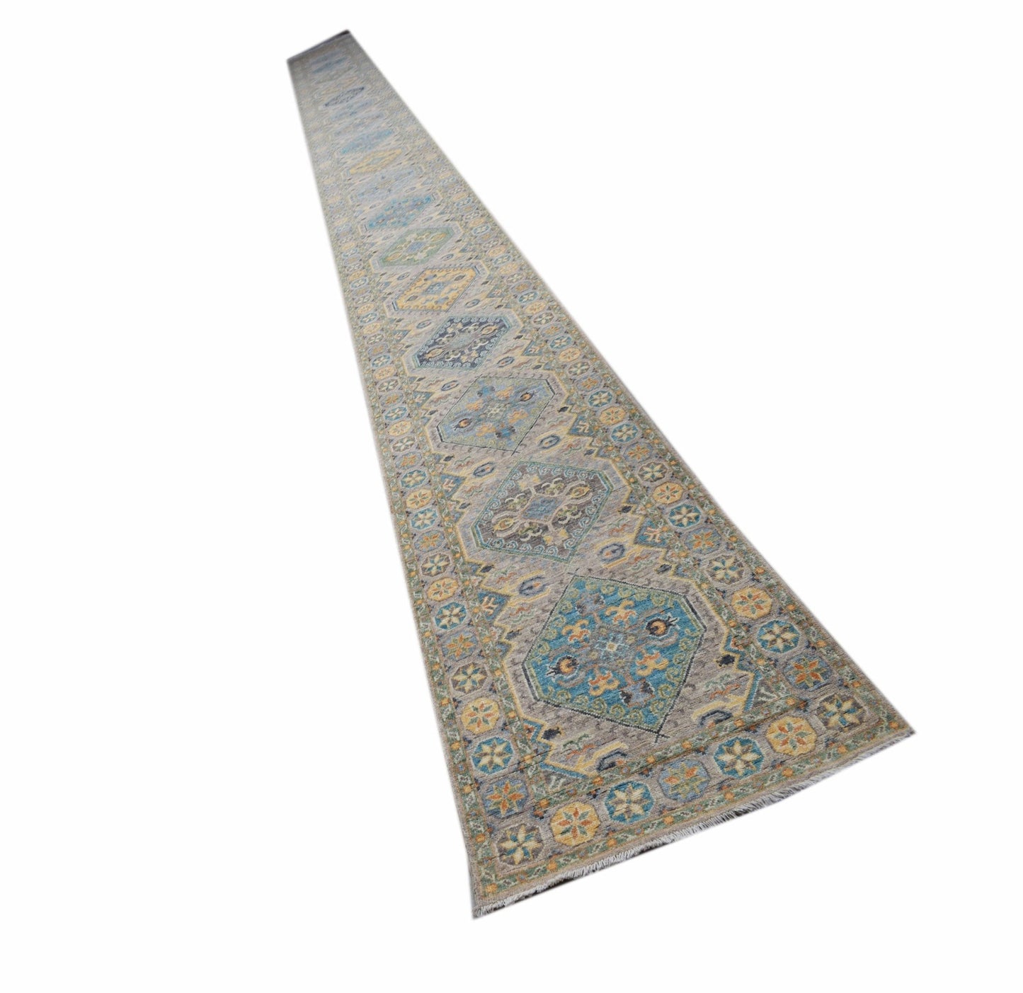 A long, handwoven Afghan Chobi runner rug featuring traditional geometric patterns in muted tones.