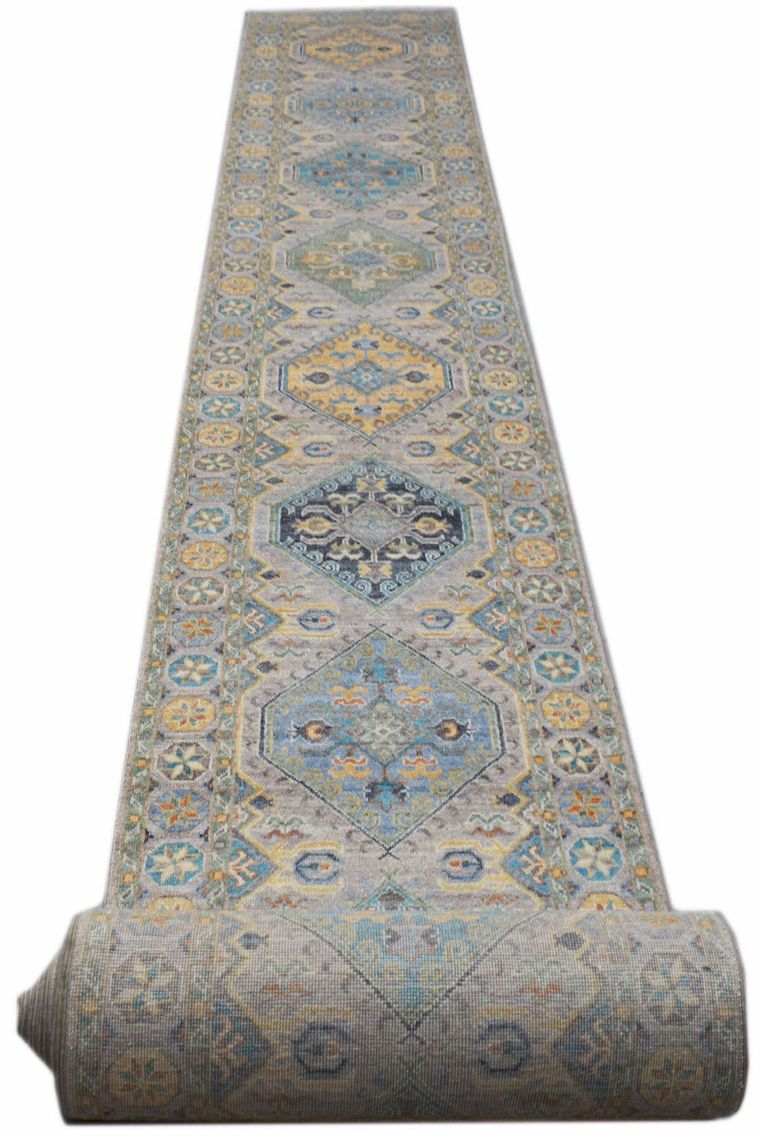 A handmade Afghan Chobi runner rug featuring a repeating geometric pattern in blue and yellow.