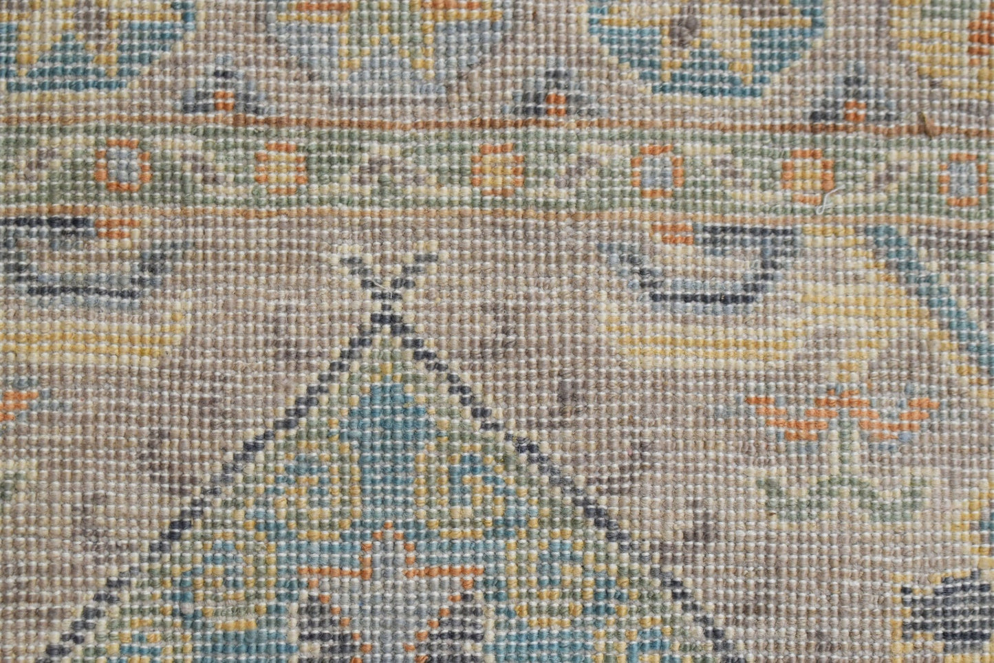 A close-up view of a handwoven Afghan Chobi runner featuring intricate geometric patterns.