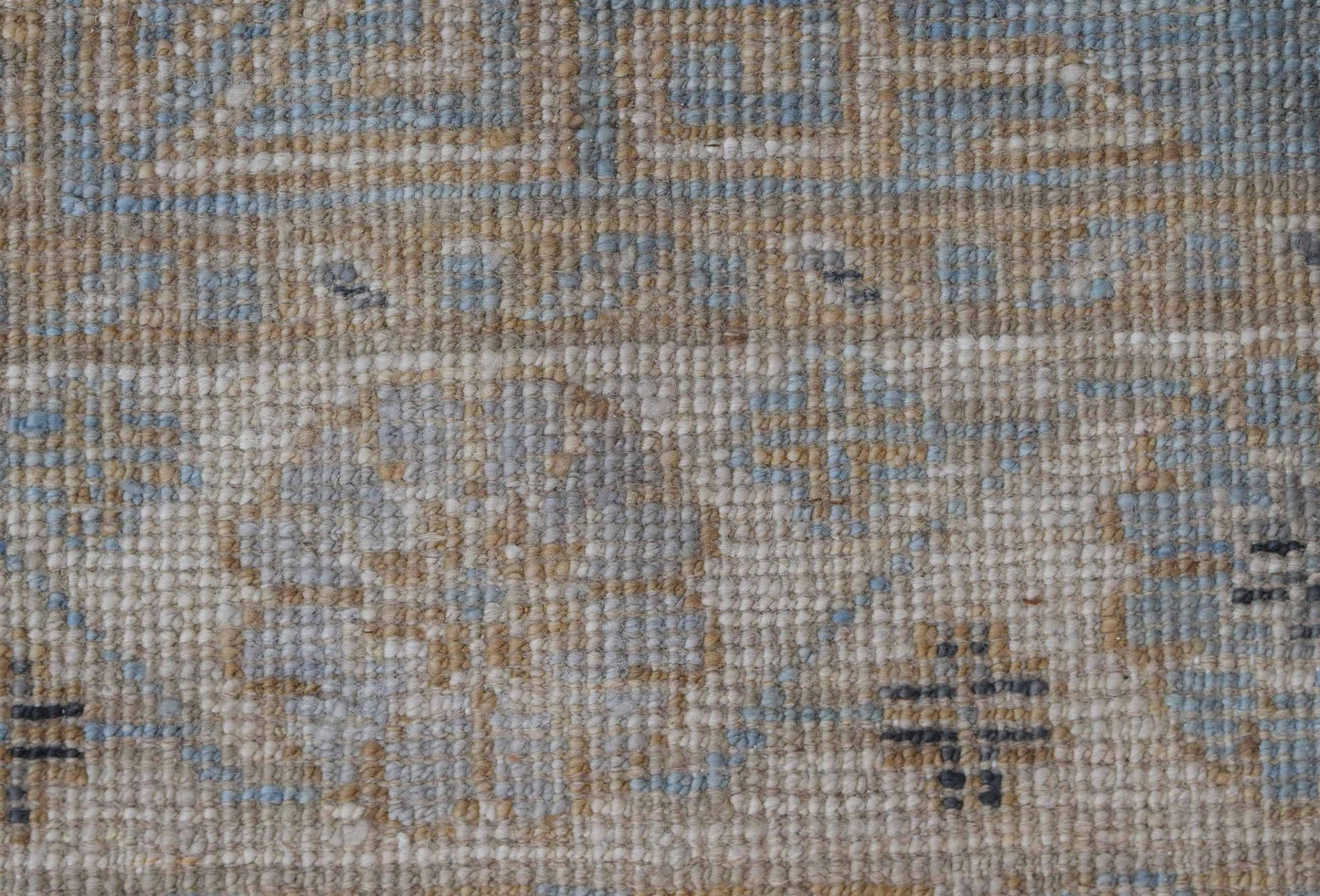 A close-up of a handwoven Afghan Chobi runner featuring a textured wool pattern in blue and tan.
