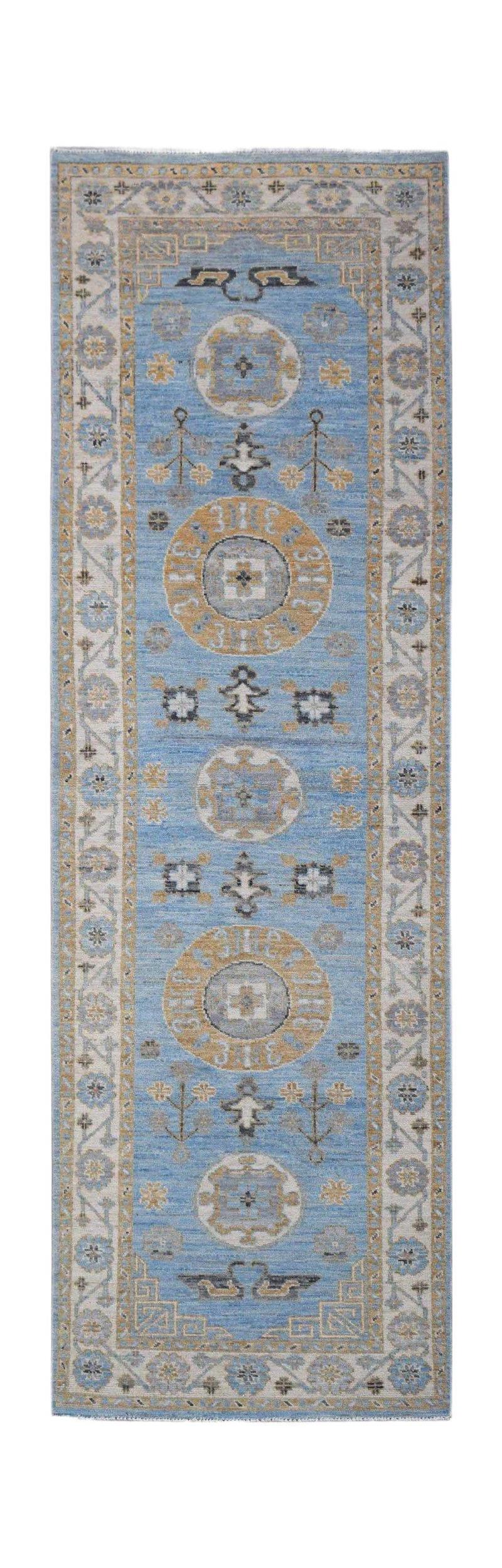 A handwoven Afghan Chobi runner rug featuring traditional circular motifs in blue and tan tones.