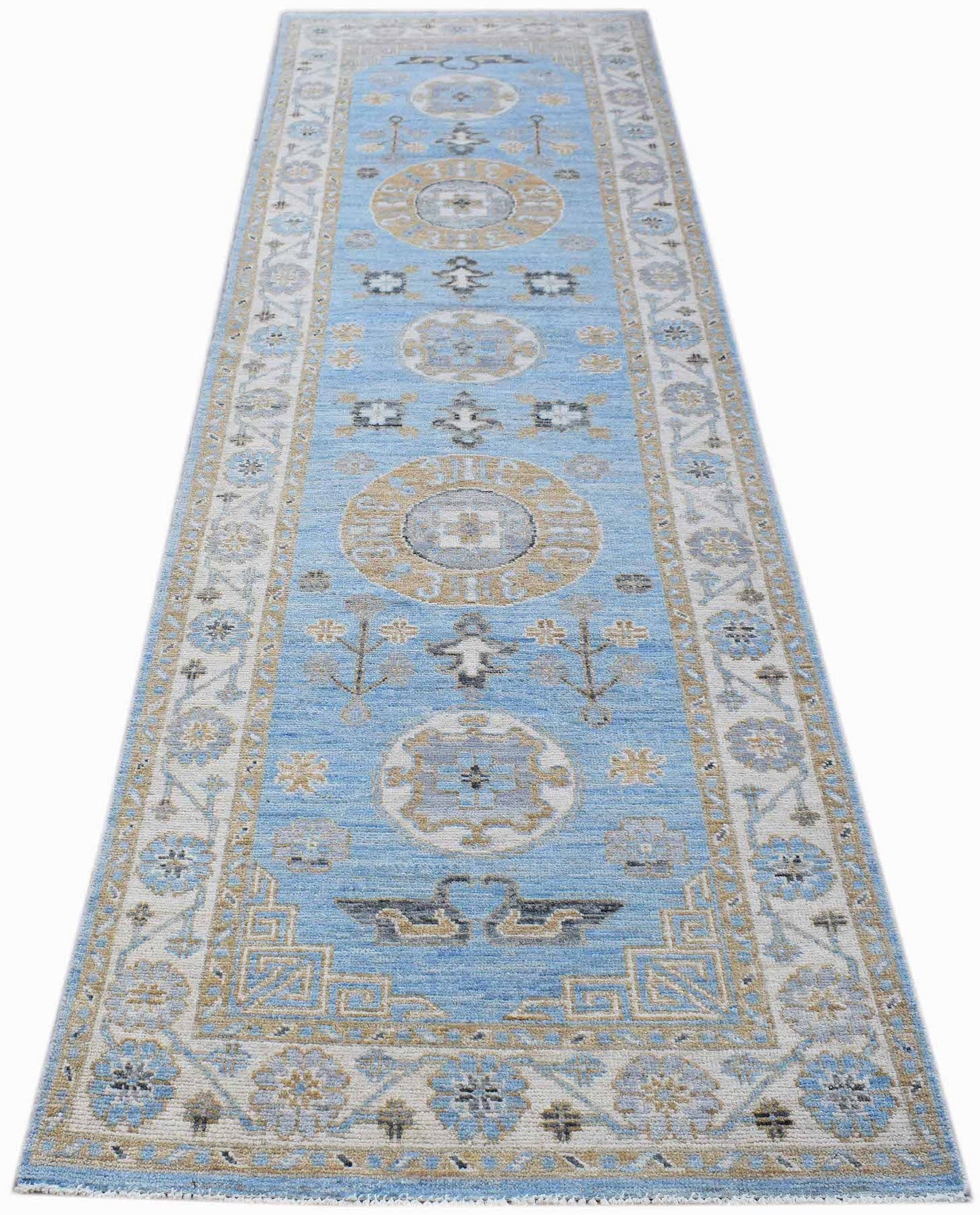 A handwoven Afghan Chobi runner rug featuring traditional geometric patterns in blue and beige.