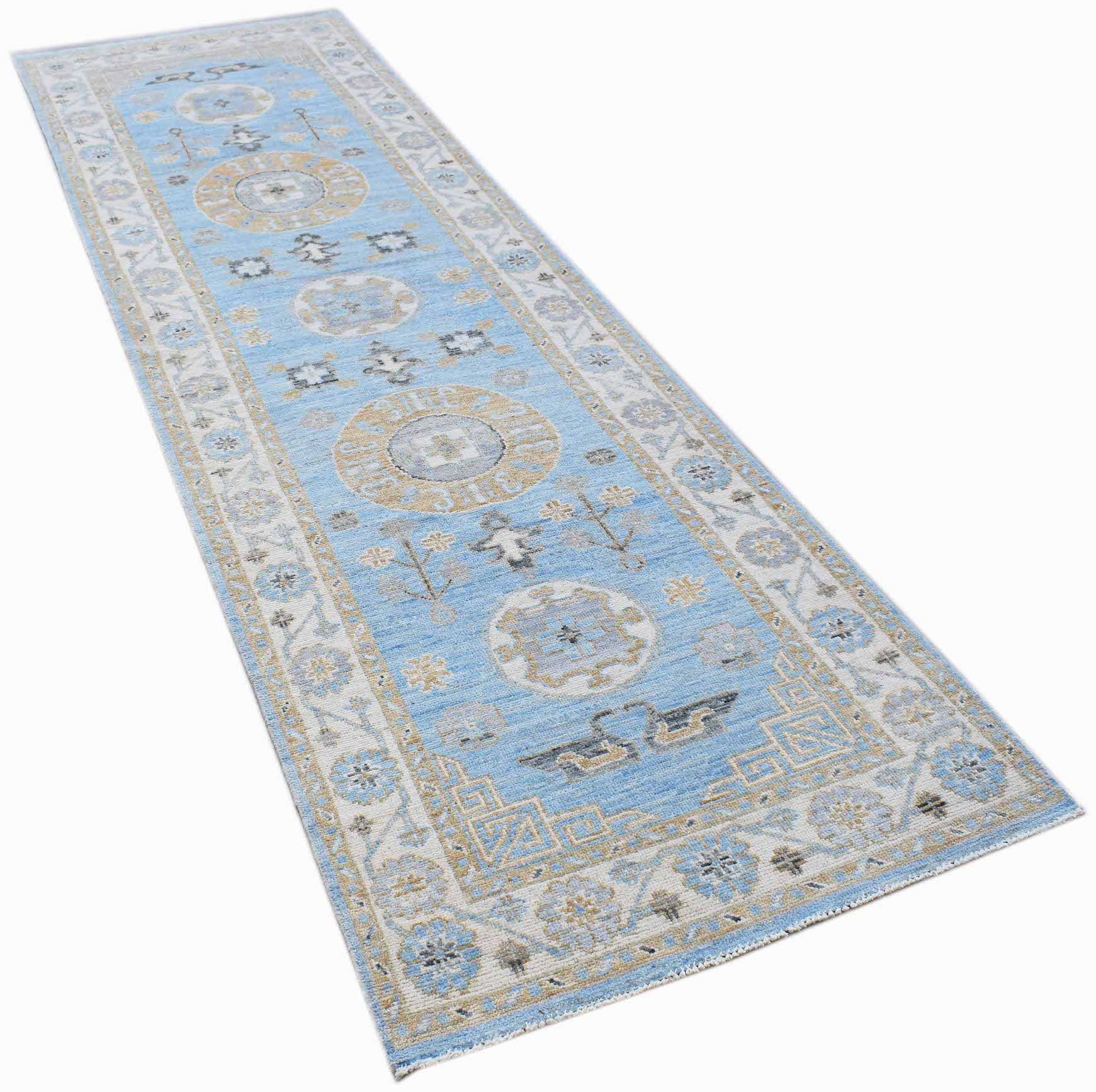 A handmade Afghan Chobi runner rug featuring traditional patterns in blue, beige, and grey tones.