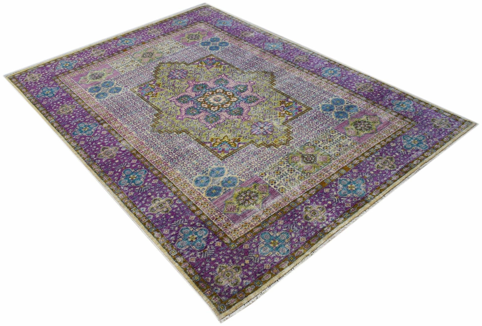 An Afghan Balkh rug featuring a traditional floral medallion pattern in purple, green, and blue.