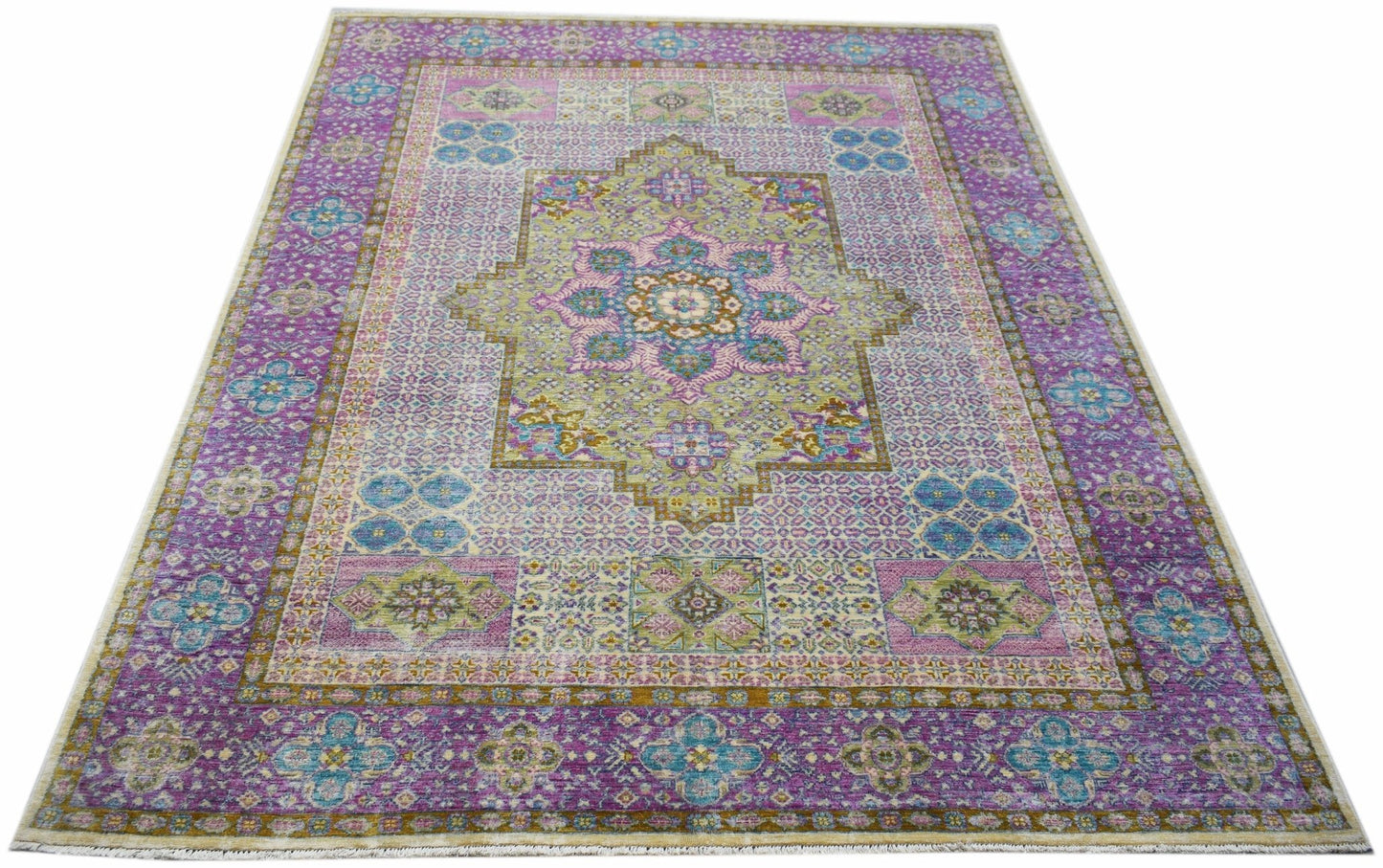 A rectangular Afghan Balkh rug featuring a traditional floral medallion in purple and green tones.