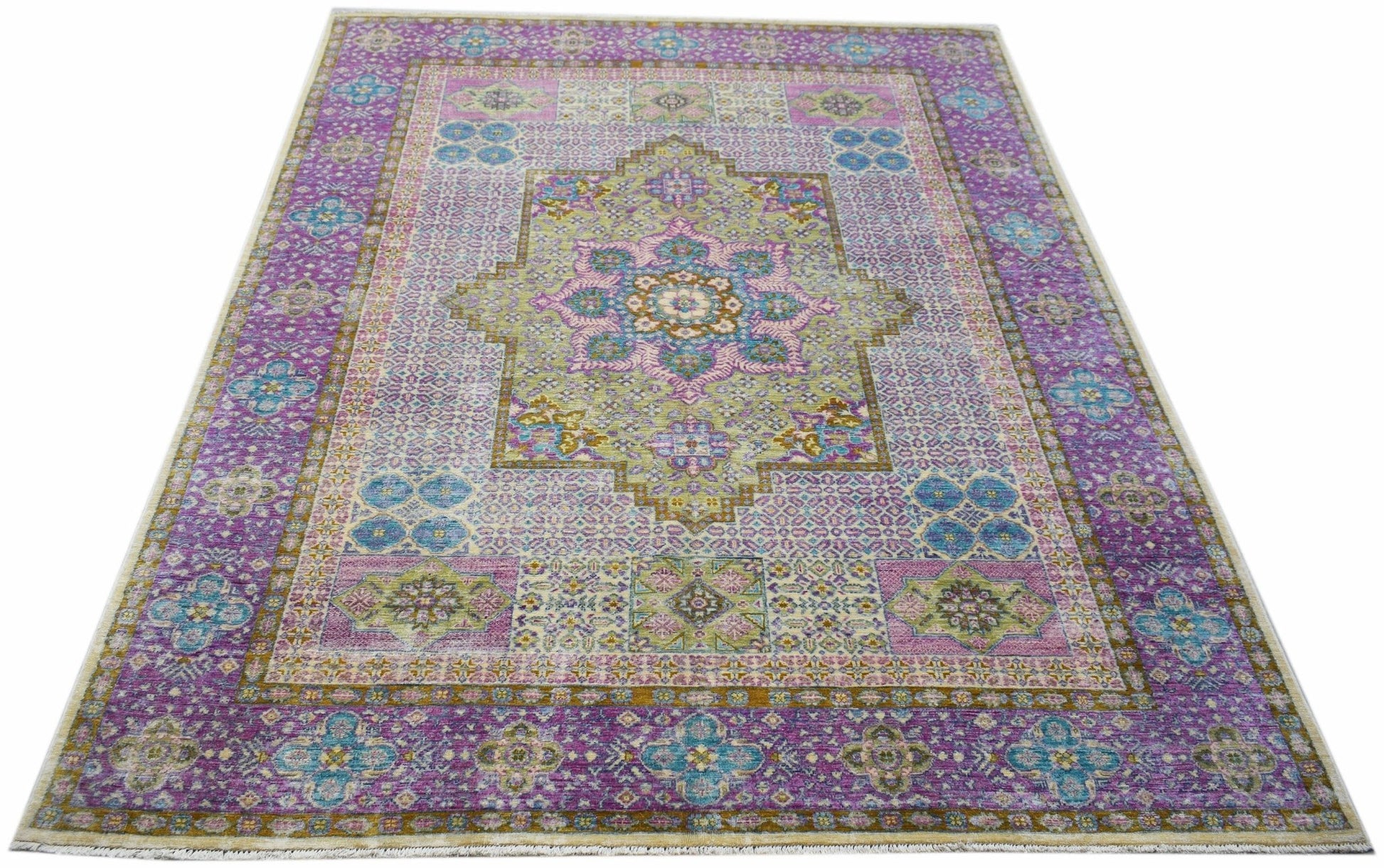 A rectangular Afghan Balkh rug featuring a traditional floral medallion in purple and green tones.