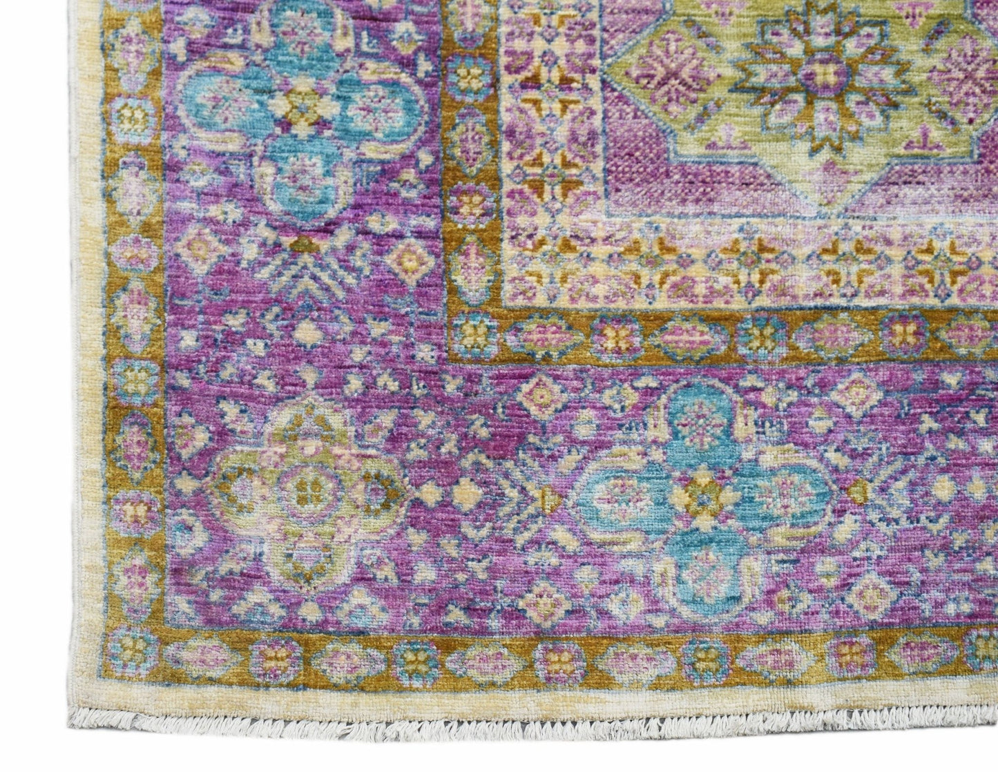 A handwoven Afghan Balkh rug featuring intricate floral patterns in shades of purple and teal.