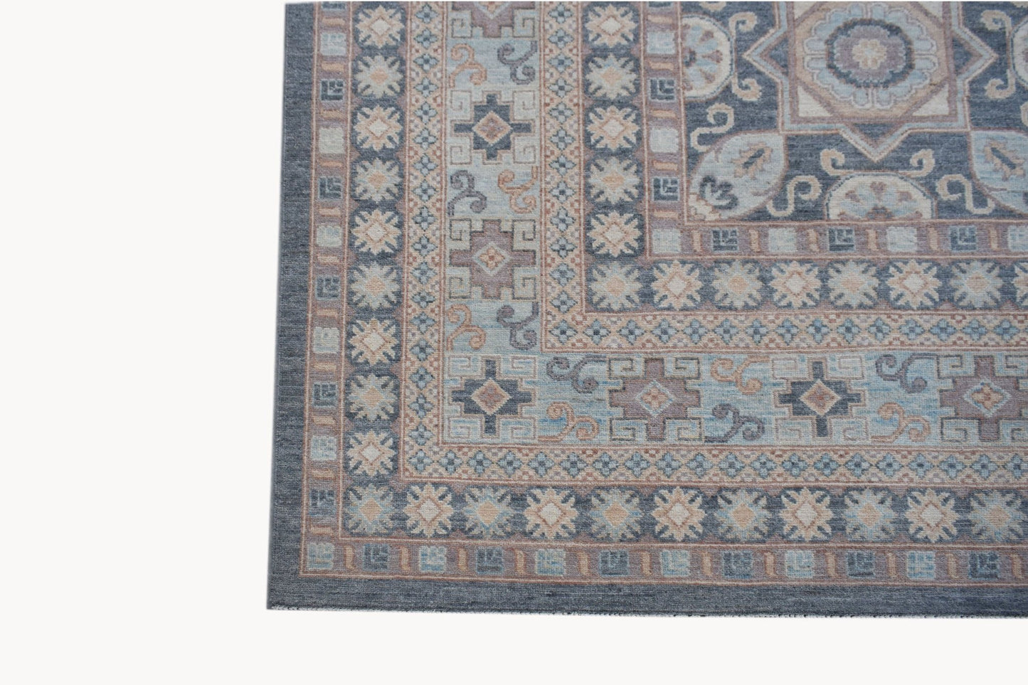 A handwoven Afghan Chobi rug featuring a traditional geometric pattern in blue and beige tones.