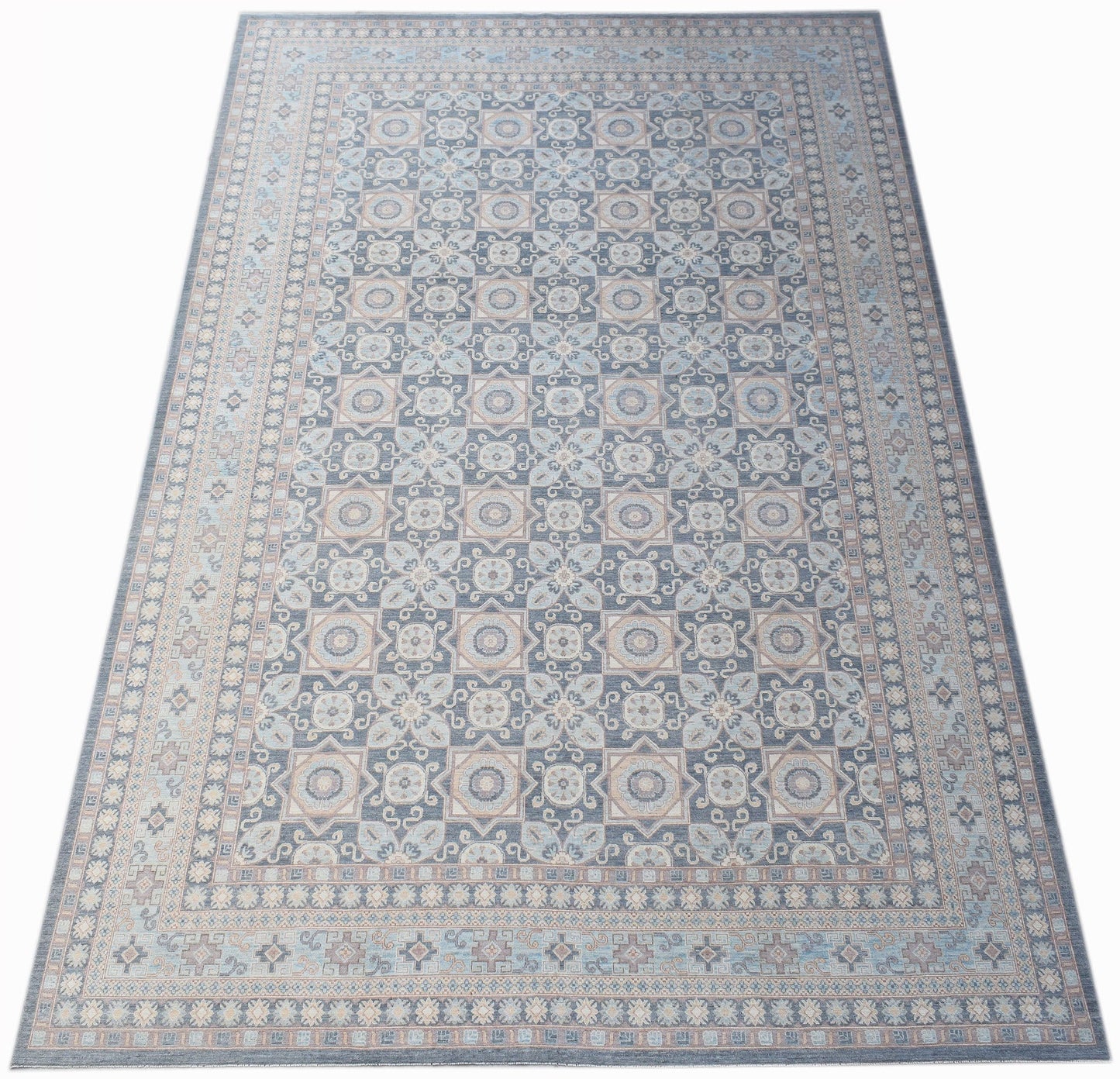 A rectangular Afghan Chobi rug featuring a repeating geometric pattern in shades of blue and beige.