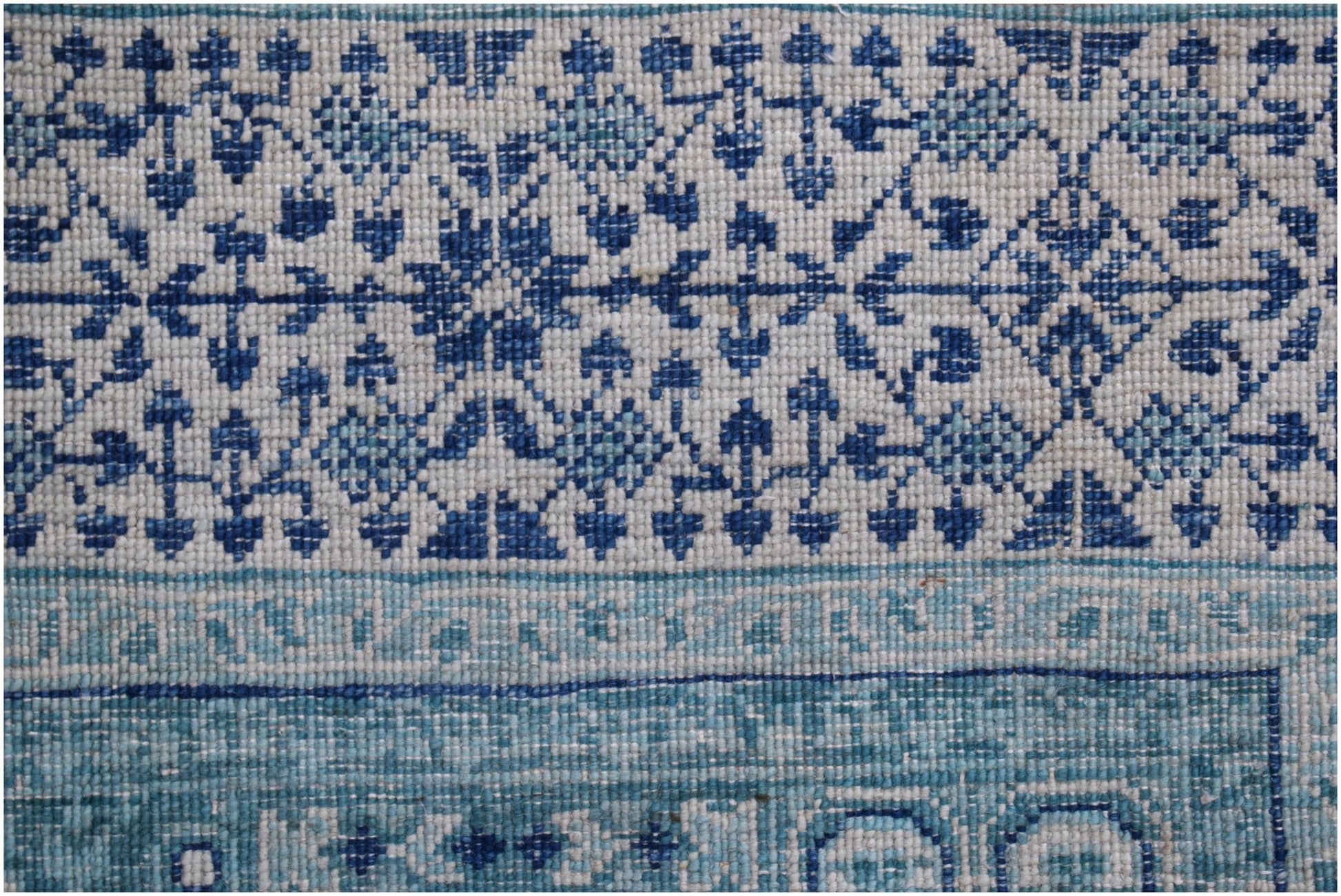 A handwoven Afghan Chobi rug featuring a detailed blue and white Mamluk geometric pattern.