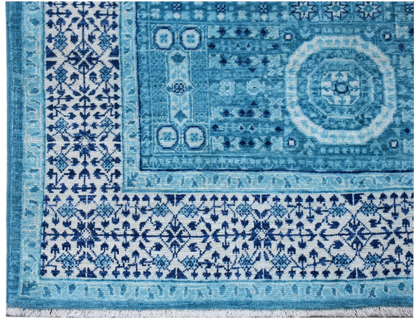 A handwoven Afghan Chobi rug featuring a blue and white Mamluk medallion pattern.