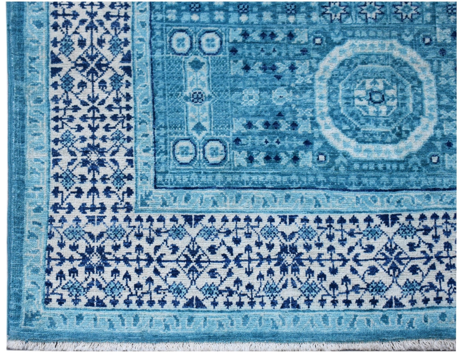 A handwoven Afghan Chobi rug featuring a blue and white Mamluk medallion pattern.