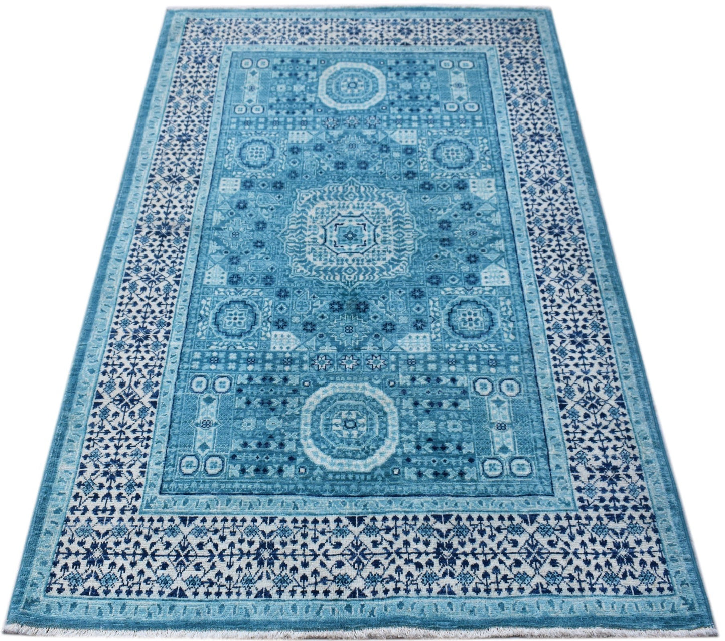 A rectangular, handwoven Afghan Chobi rug featuring a detailed blue Mamluk medallion pattern.