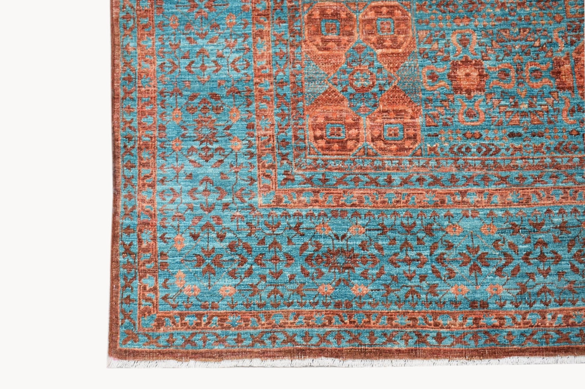 A handmade Afghan Chobi rug featuring a detailed Mamluk pattern in shades of blue and rust.