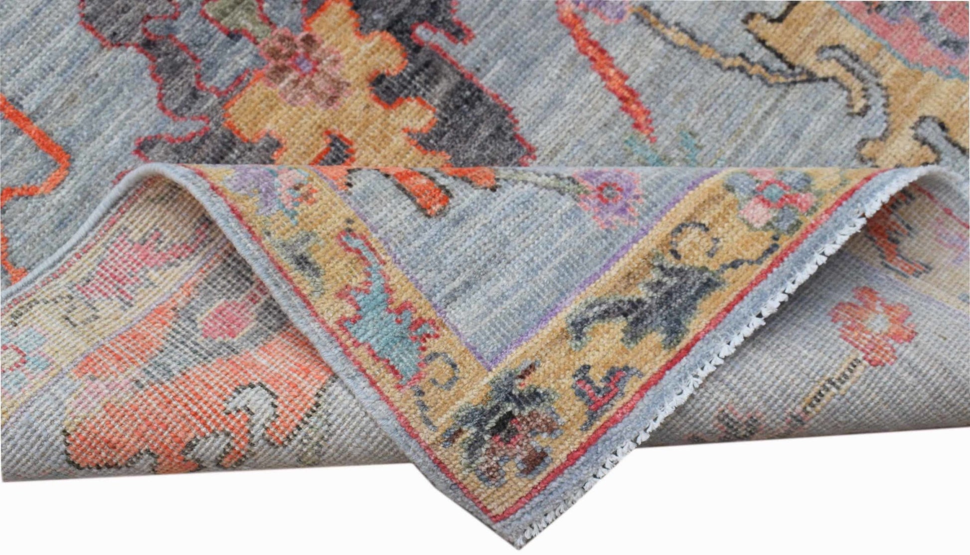 A handwoven transitional Oushak runner featuring a floral pattern in blue, orange, and yellow.