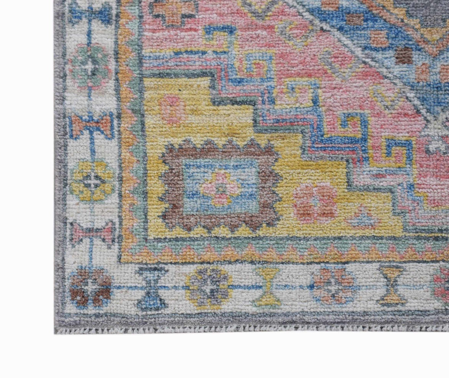 A handwoven transitional Oushak runner featuring a colorful floral pattern on a yellow background.