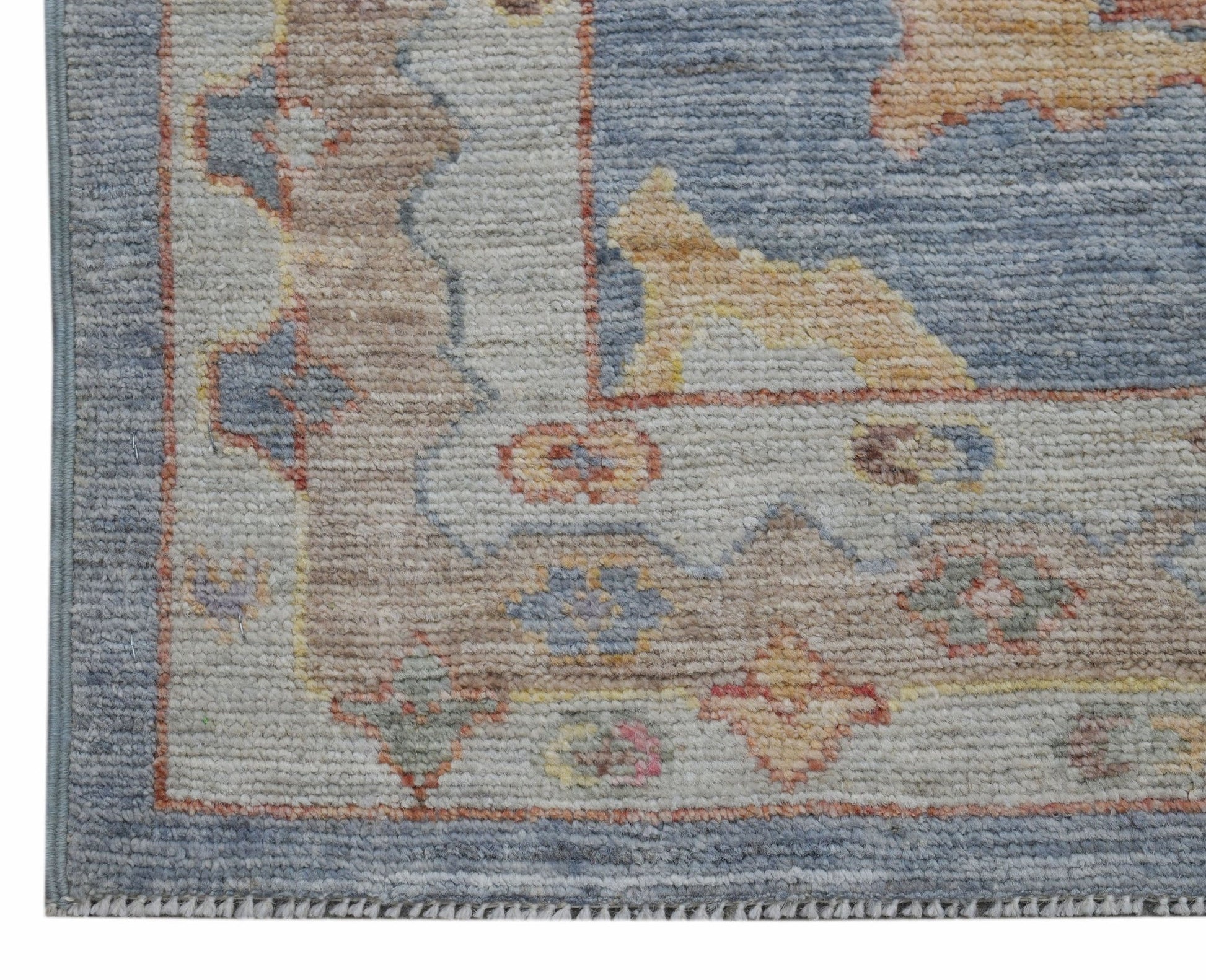 A handwoven transitional Oushak runner featuring a floral pattern in muted blue and beige tones.