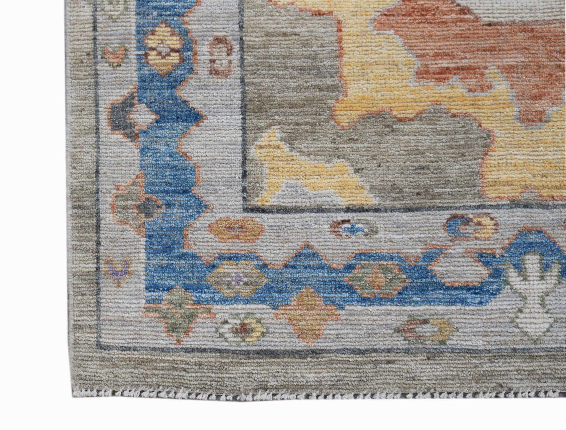 A handwoven transitional Oushak runner featuring a blue border and a multi-colored floral pattern.