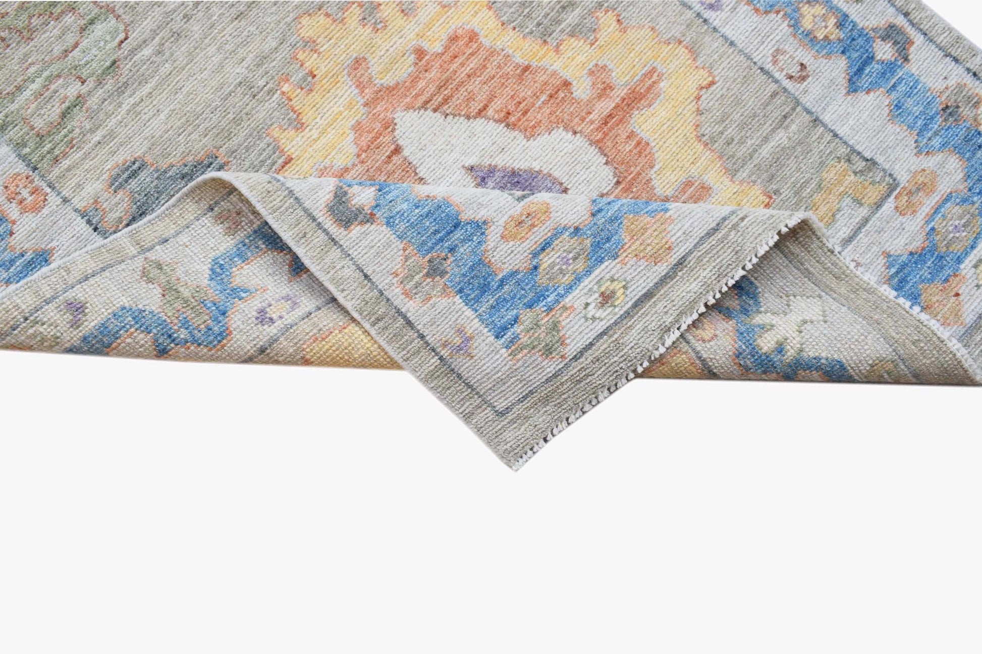 A handwoven transitional Oushak runner featuring a floral pattern in blue, orange, and yellow.