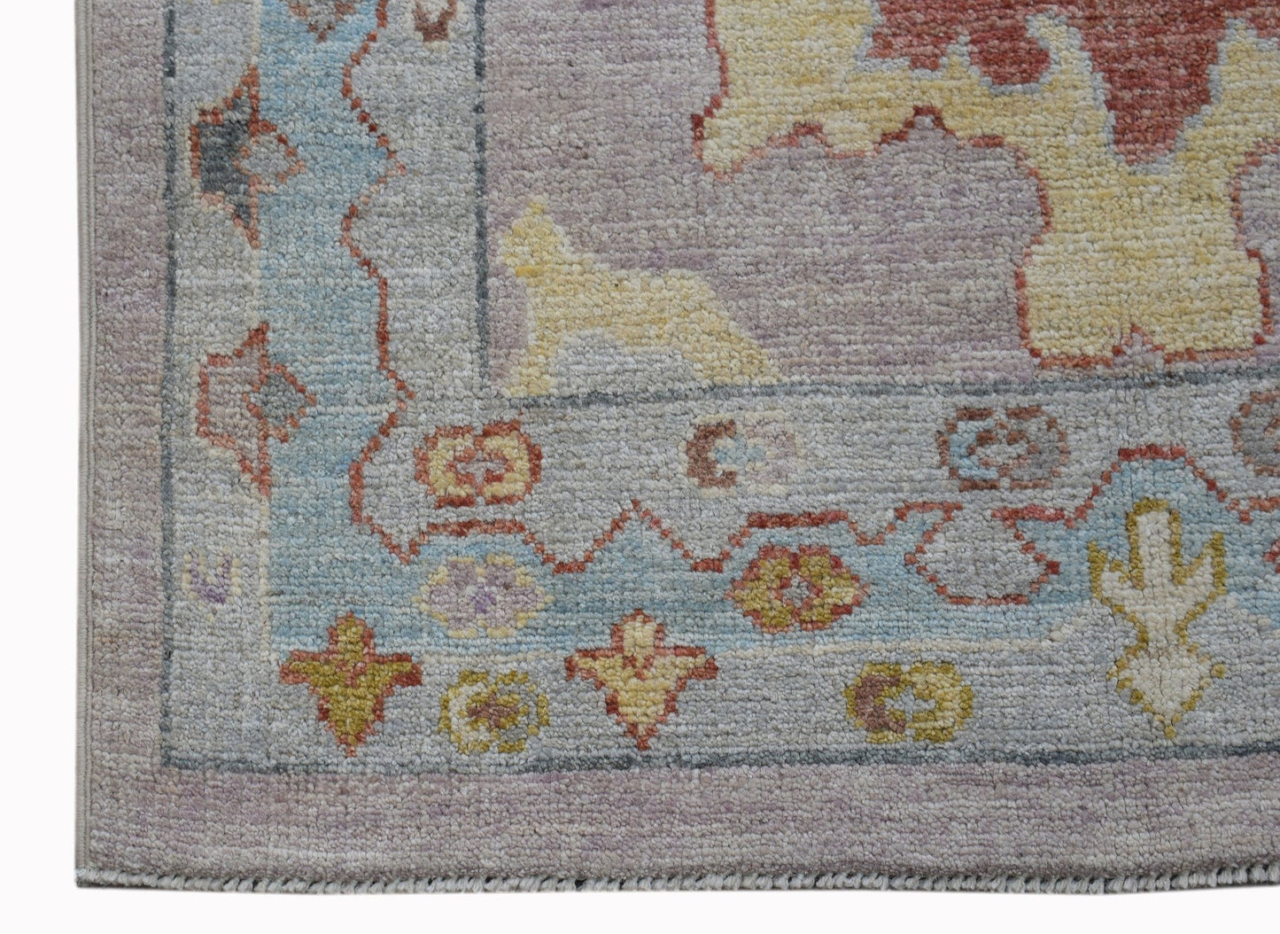 A handwoven transitional Oushak runner featuring a floral pattern in soft pastel tones.