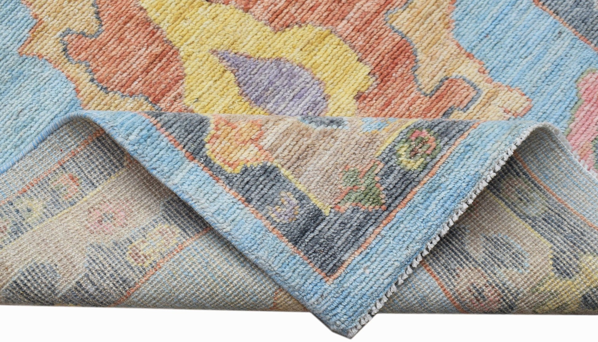 A handwoven transitional Oushak runner featuring a floral pattern in vibrant, contemporary colors.