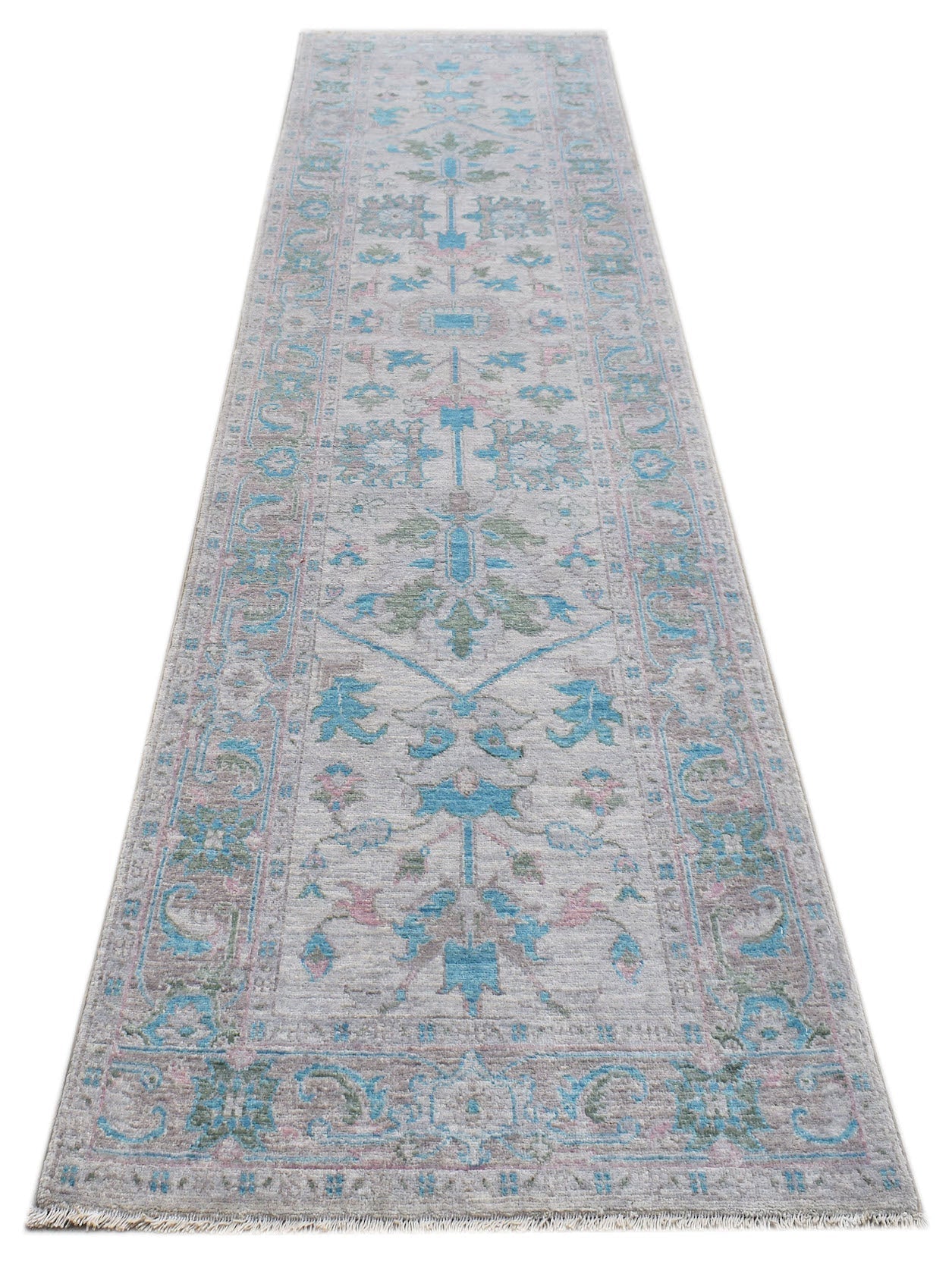 A handwoven transitional Oushak runner rug featuring a floral pattern in blue, green, and pink.