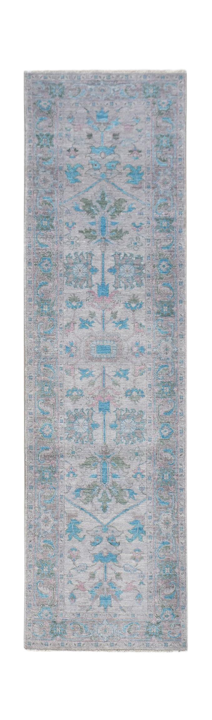 A handwoven transitional Oushak runner featuring a floral pattern in blue, pink, and green tones.