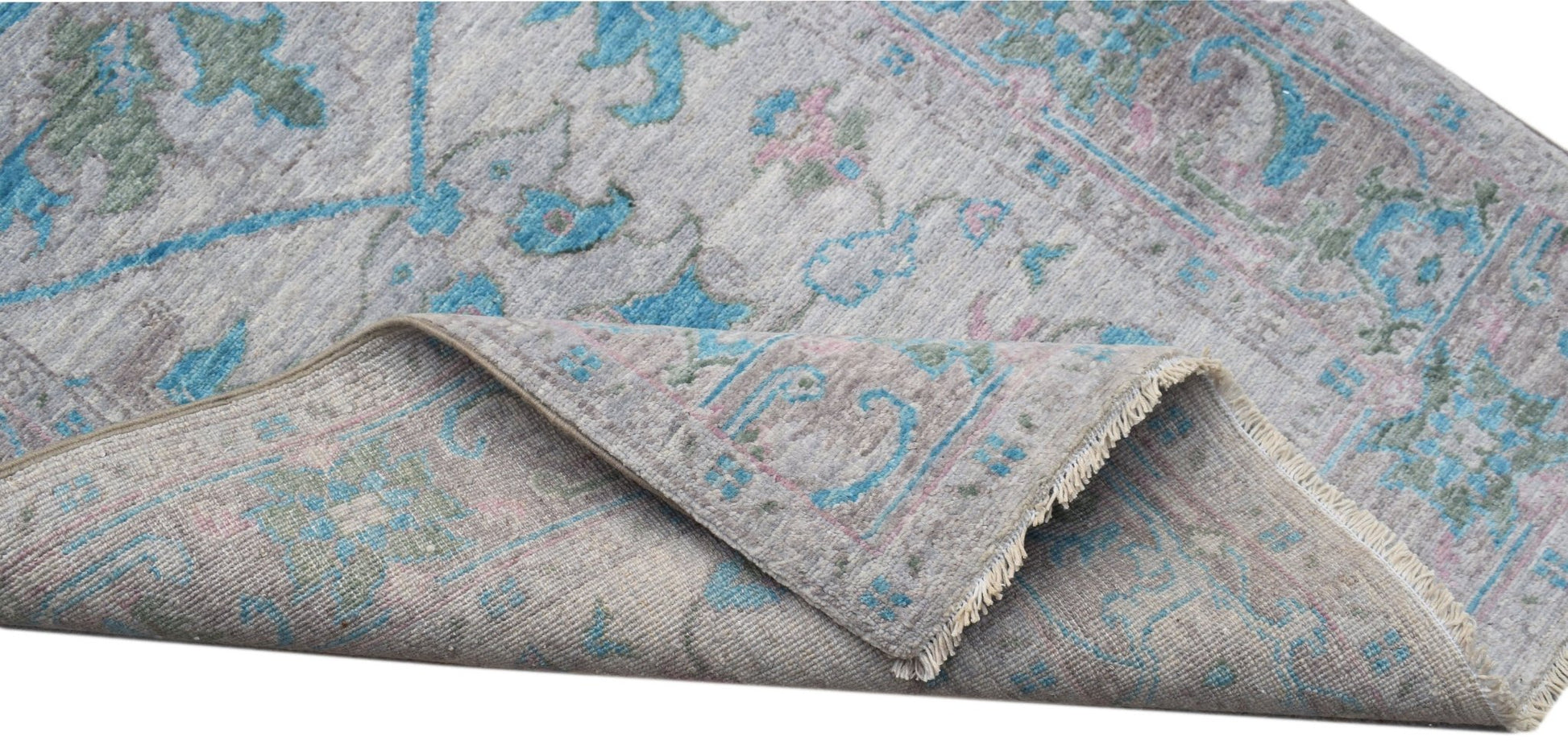 A handwoven transitional Oushak runner featuring a floral pattern in blue, pink, and grey tones.