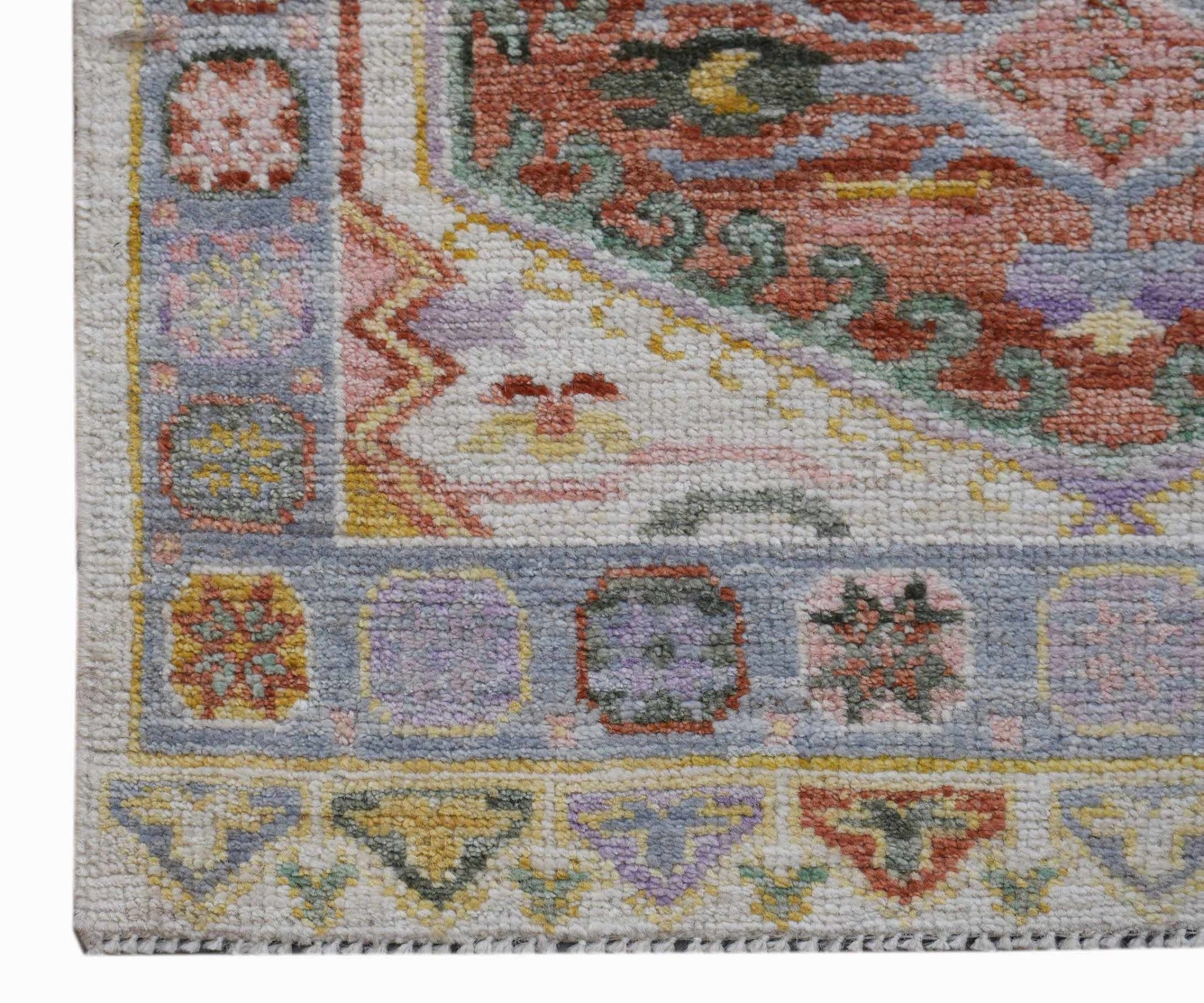 A handwoven transitional Oushak runner featuring a floral pattern in soft, contemporary colors.