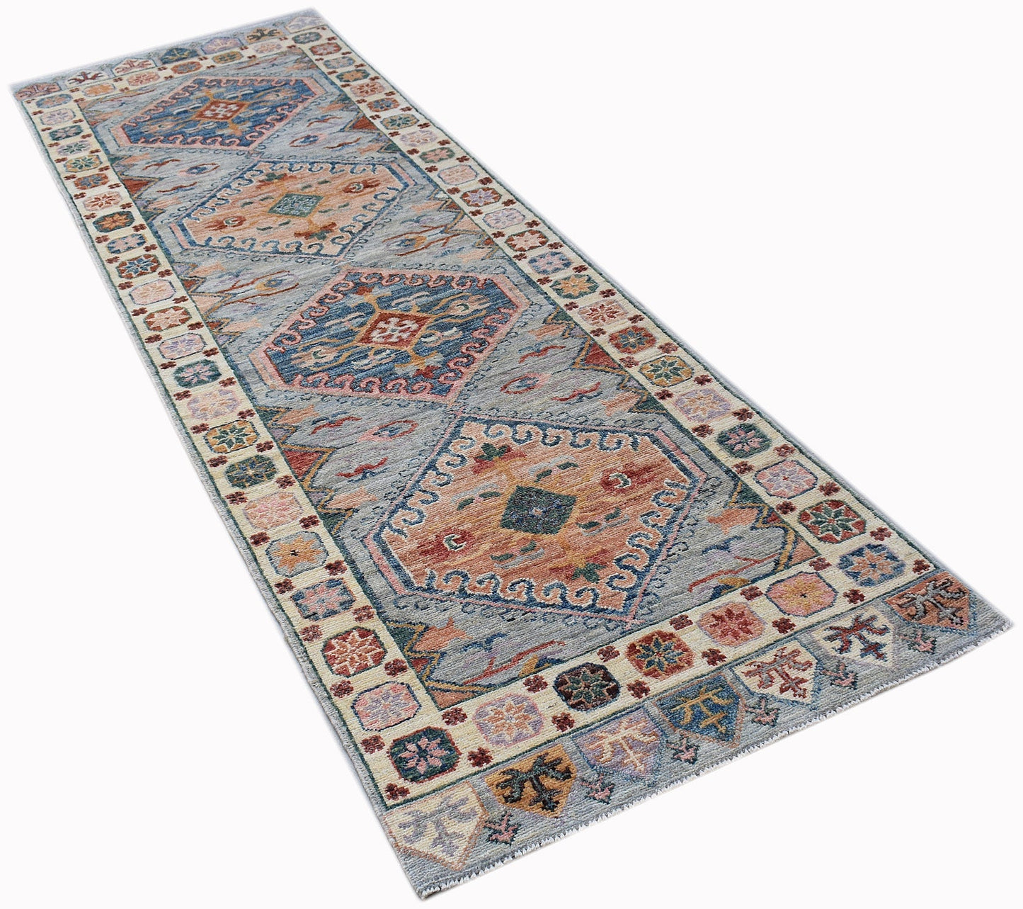 A handwoven wool runner rug featuring a transitional Oushak pattern in blue and orange tones.