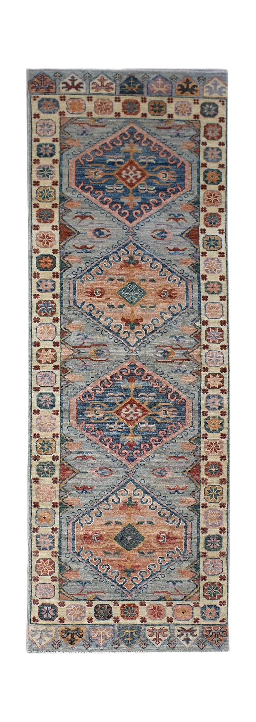 A handwoven transitional Oushak runner featuring a blue and peach geometric pattern.