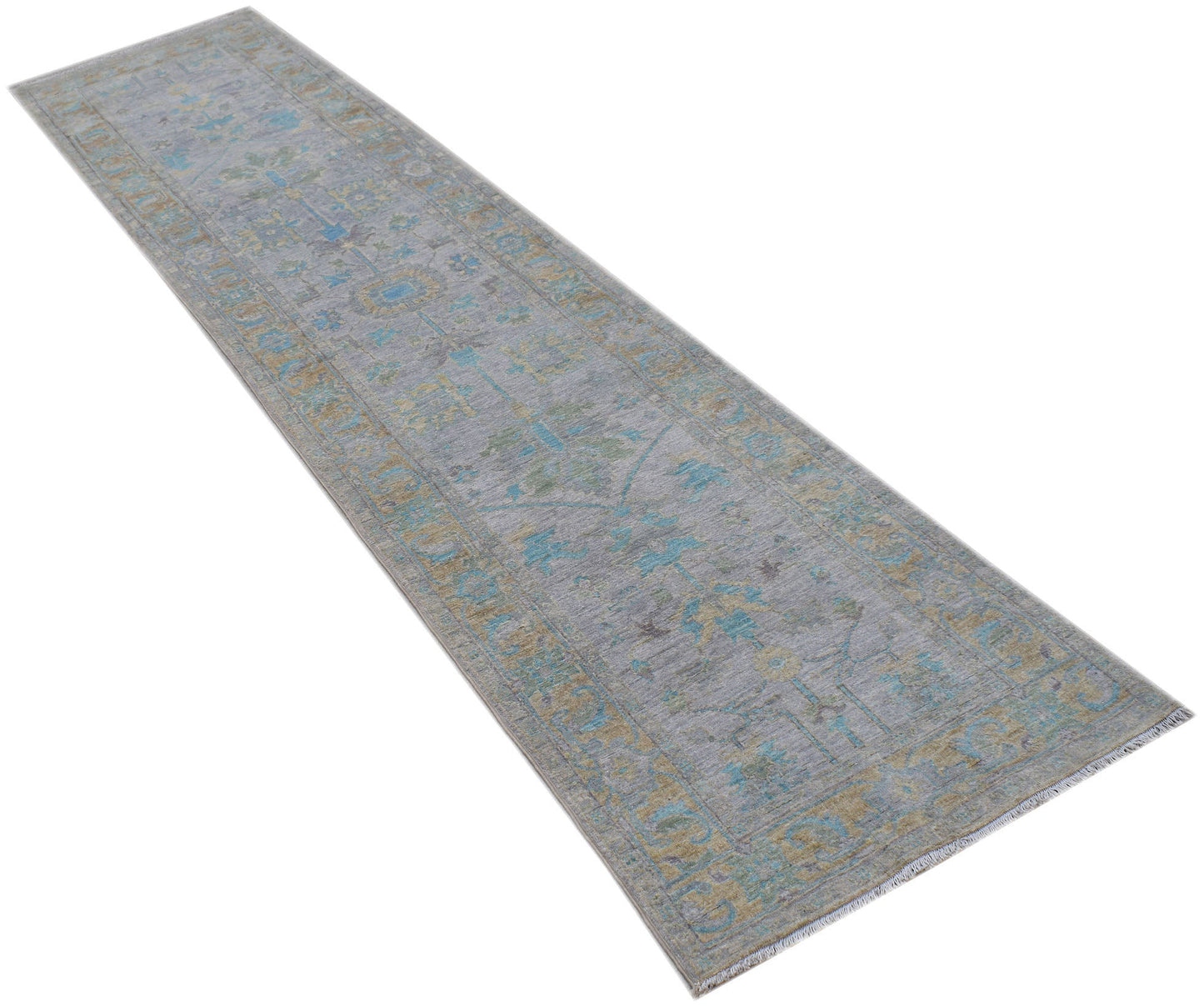 A handwoven transitional Oushak runner rug featuring a floral pattern in blue and gold on a grey base.