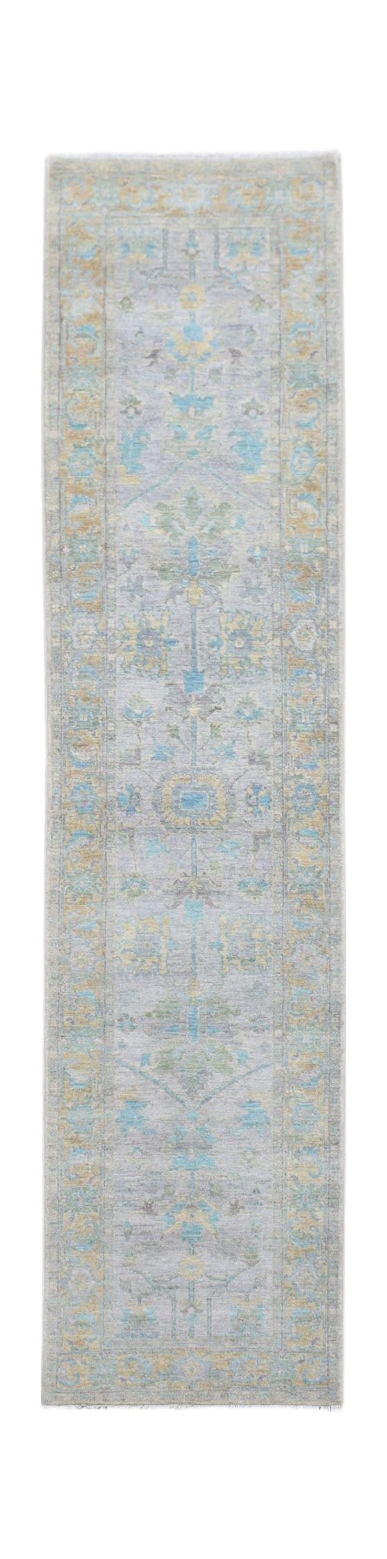 A handwoven transitional Oushak runner rug featuring a floral pattern in blue, yellow, and grey.
