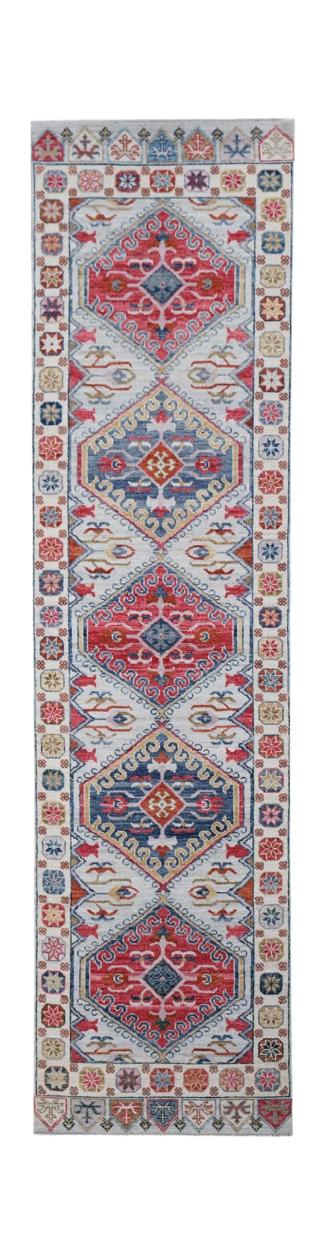 A handwoven transitional Oushak runner featuring a repeating geometric pattern in red and blue.