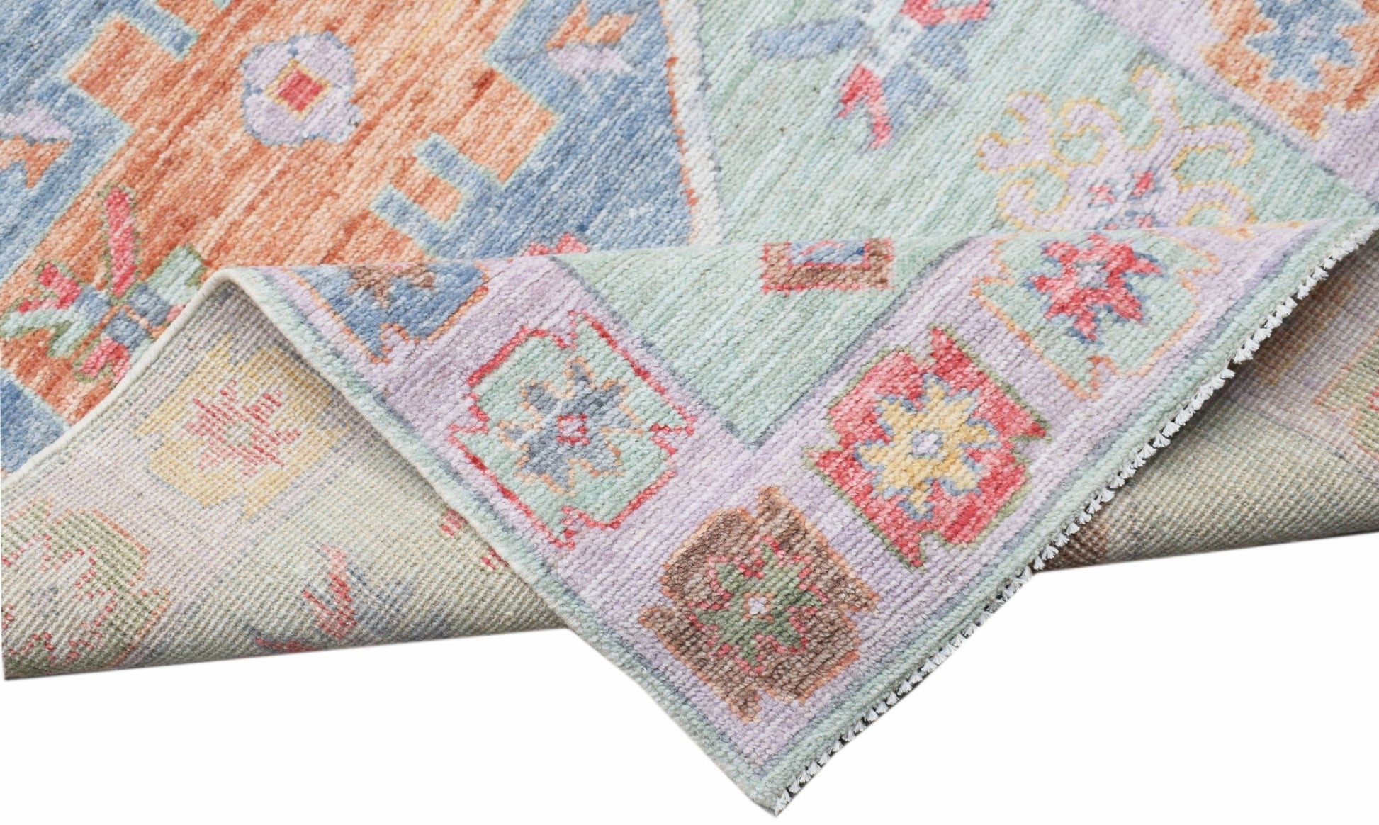 A handwoven transitional Oushak runner featuring a colorful floral pattern on a wool pile.
