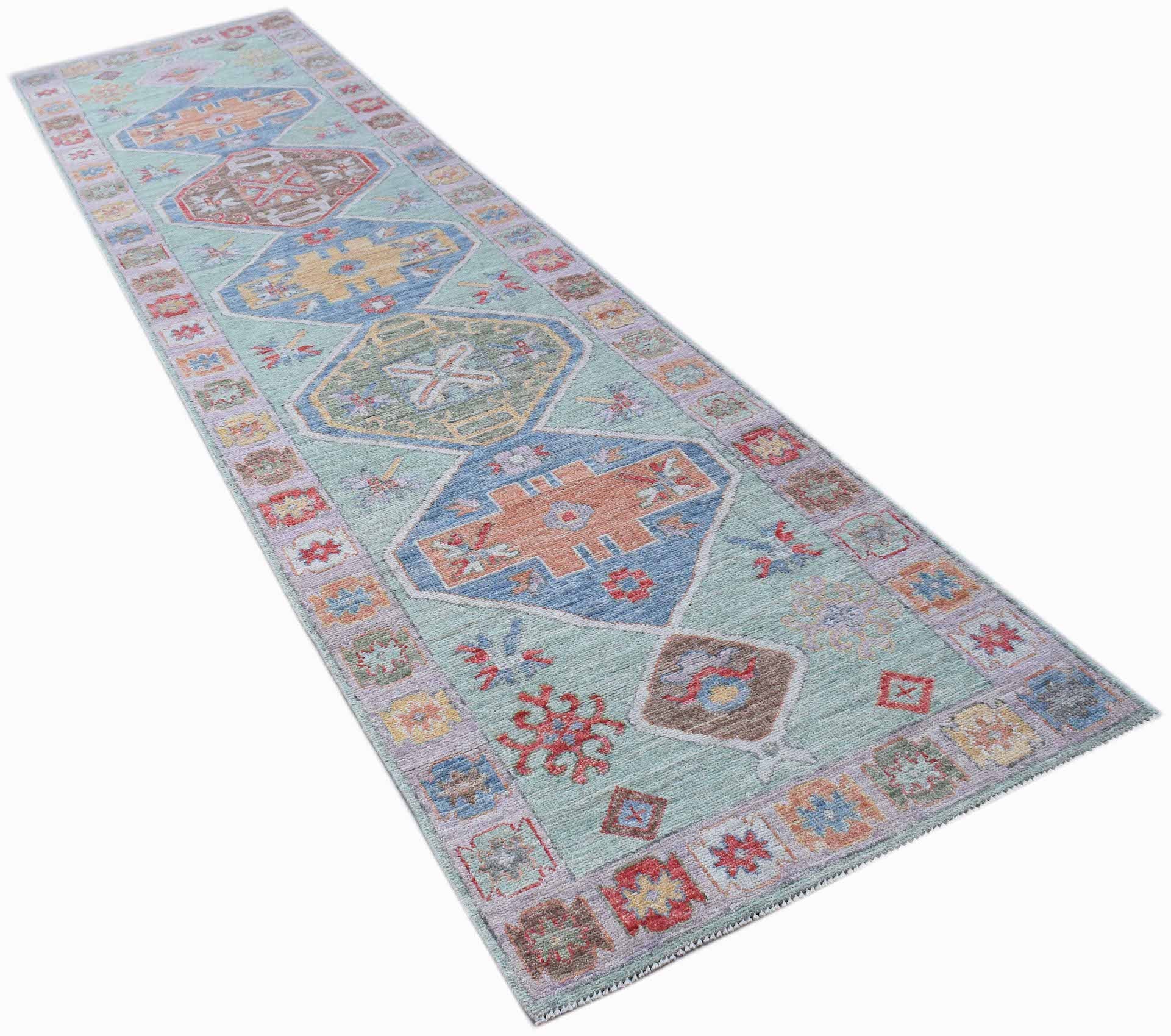 A handwoven transitional Oushak runner featuring geometric patterns in a soft blue color palette.
