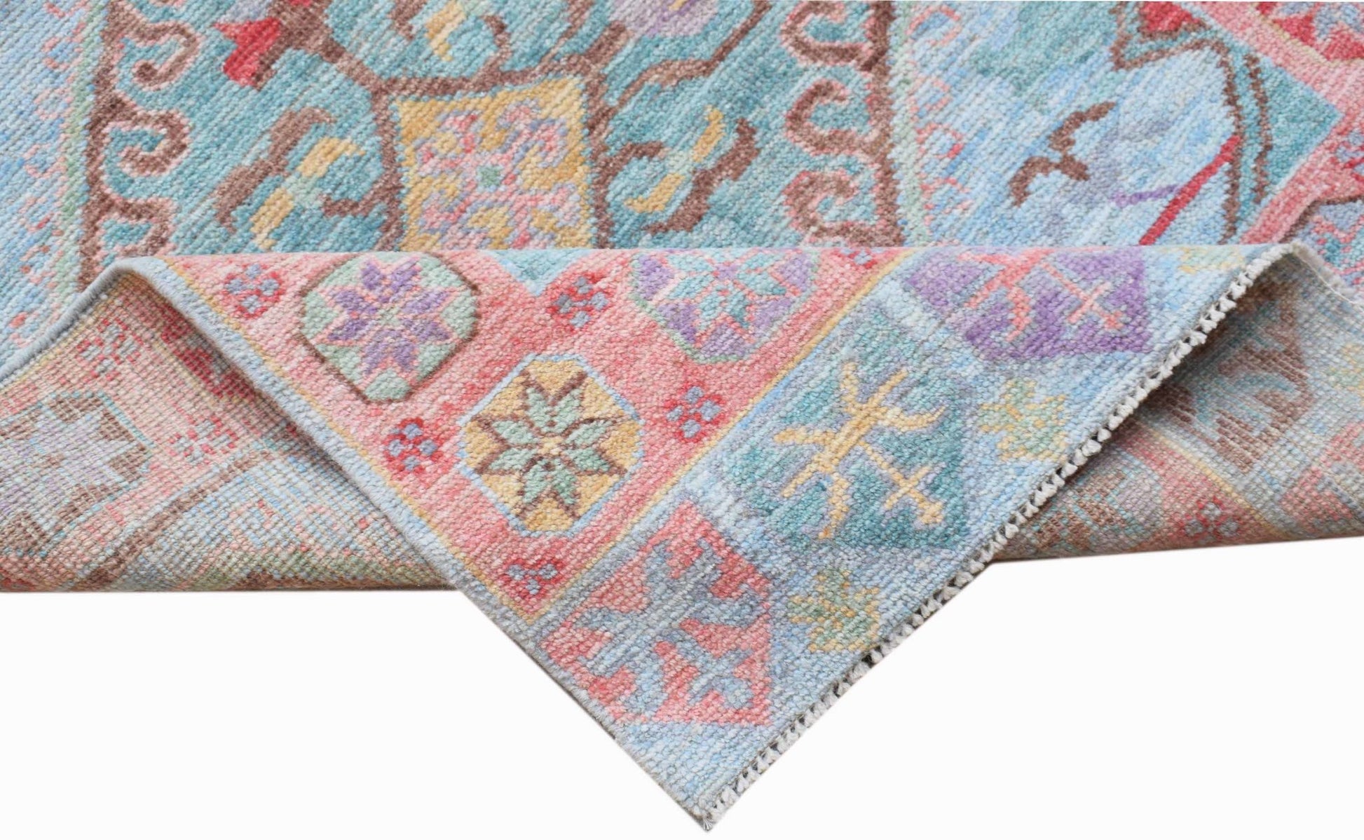 A handwoven transitional Oushak runner featuring a floral pattern in soft pastel colors.