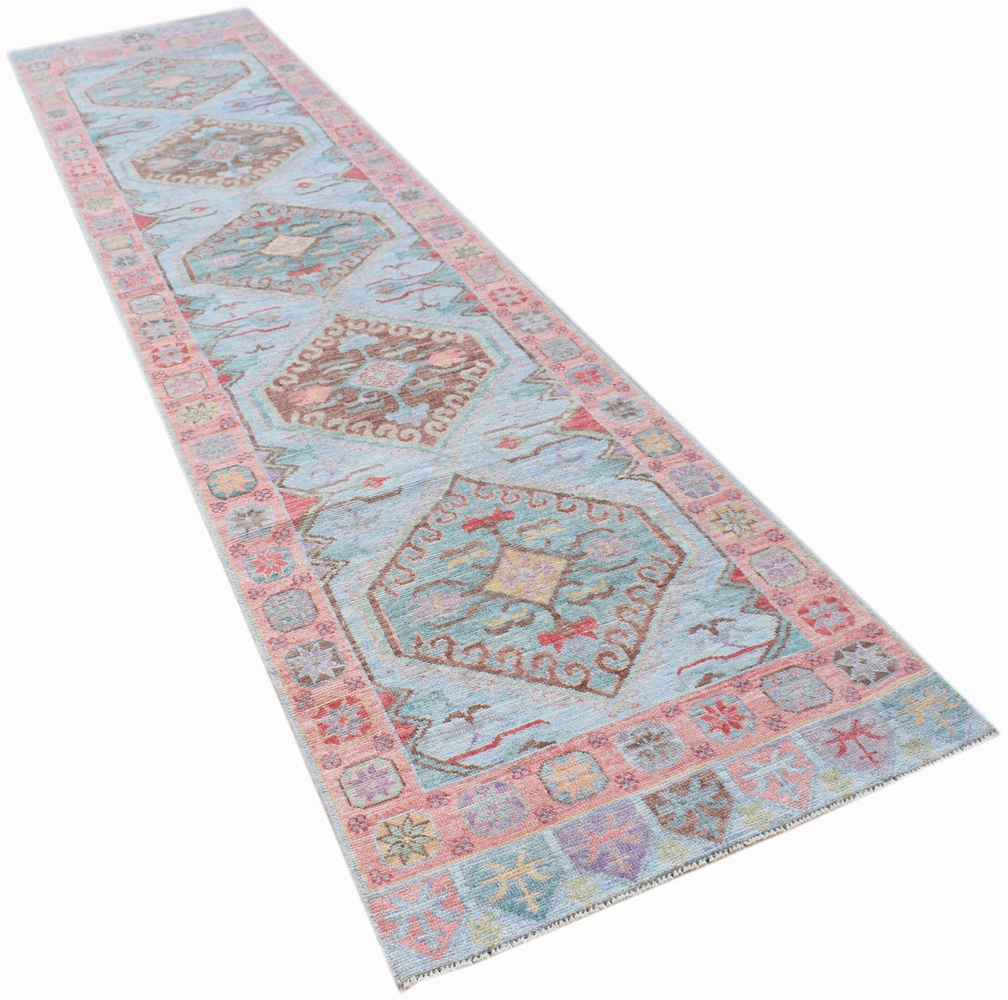 A handwoven transitional Oushak runner rug featuring a light blue field with geometric floral motifs.