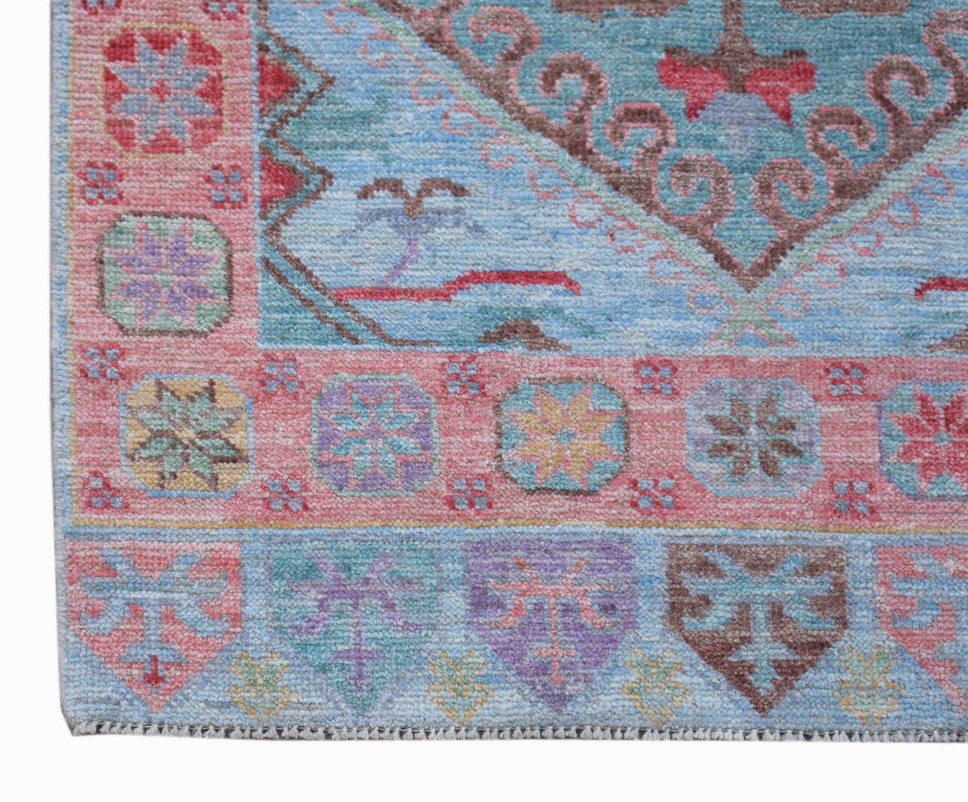 A handwoven transitional Oushak runner featuring a light blue field with colorful floral motifs.