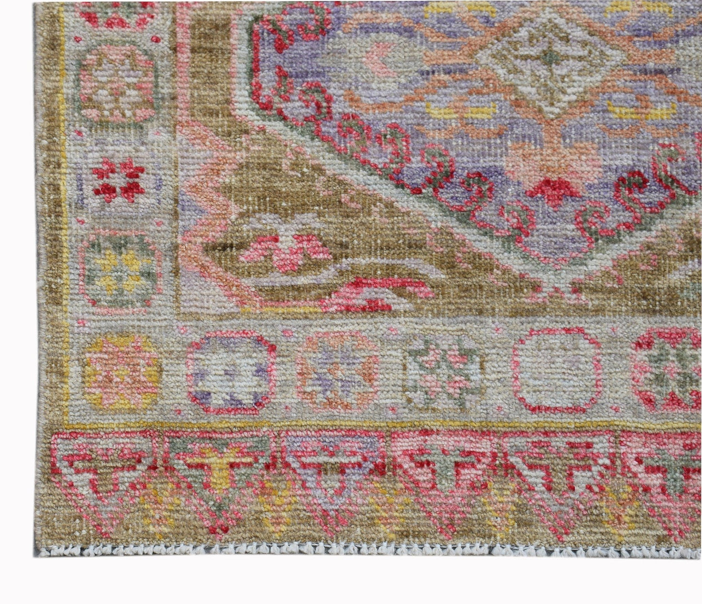 A handwoven wool runner featuring a traditional Oushak pattern in vibrant, contemporary colors.