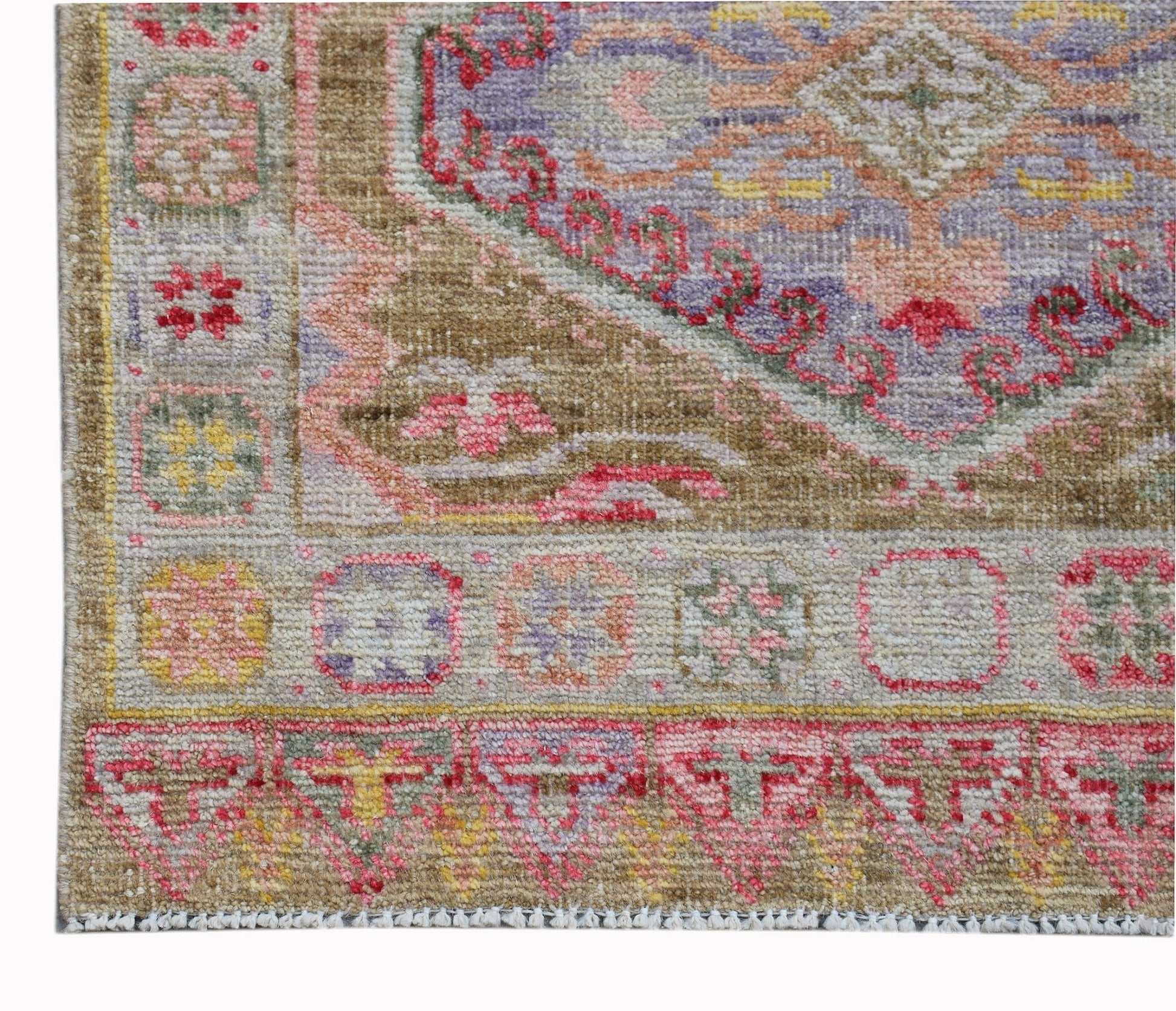 A handwoven wool runner featuring a traditional Oushak pattern in vibrant, contemporary colors.