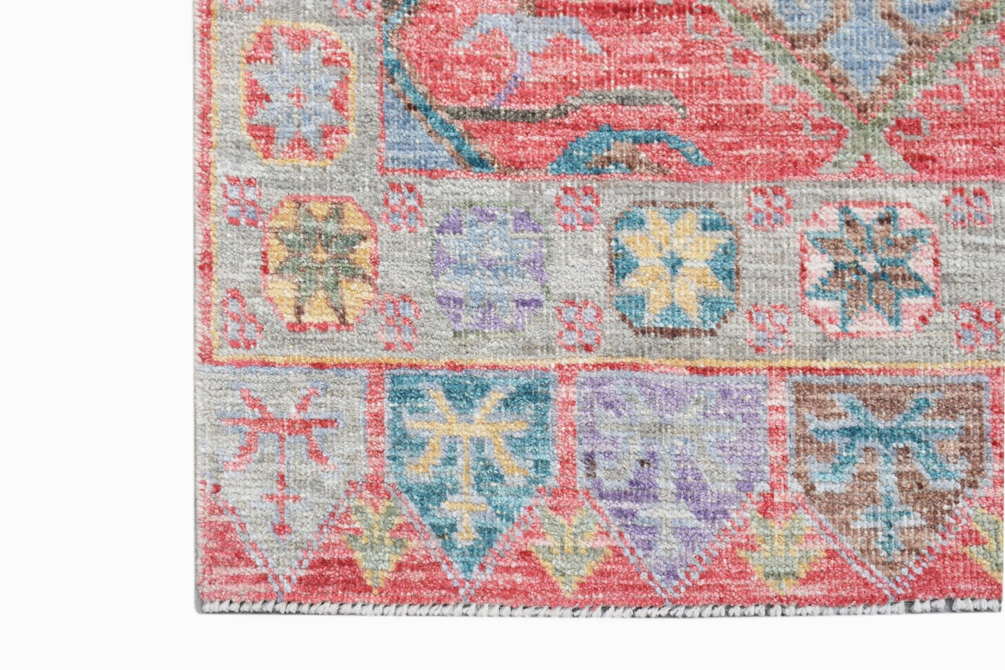 A handwoven transitional Oushak runner featuring a colorful geometric and floral pattern.