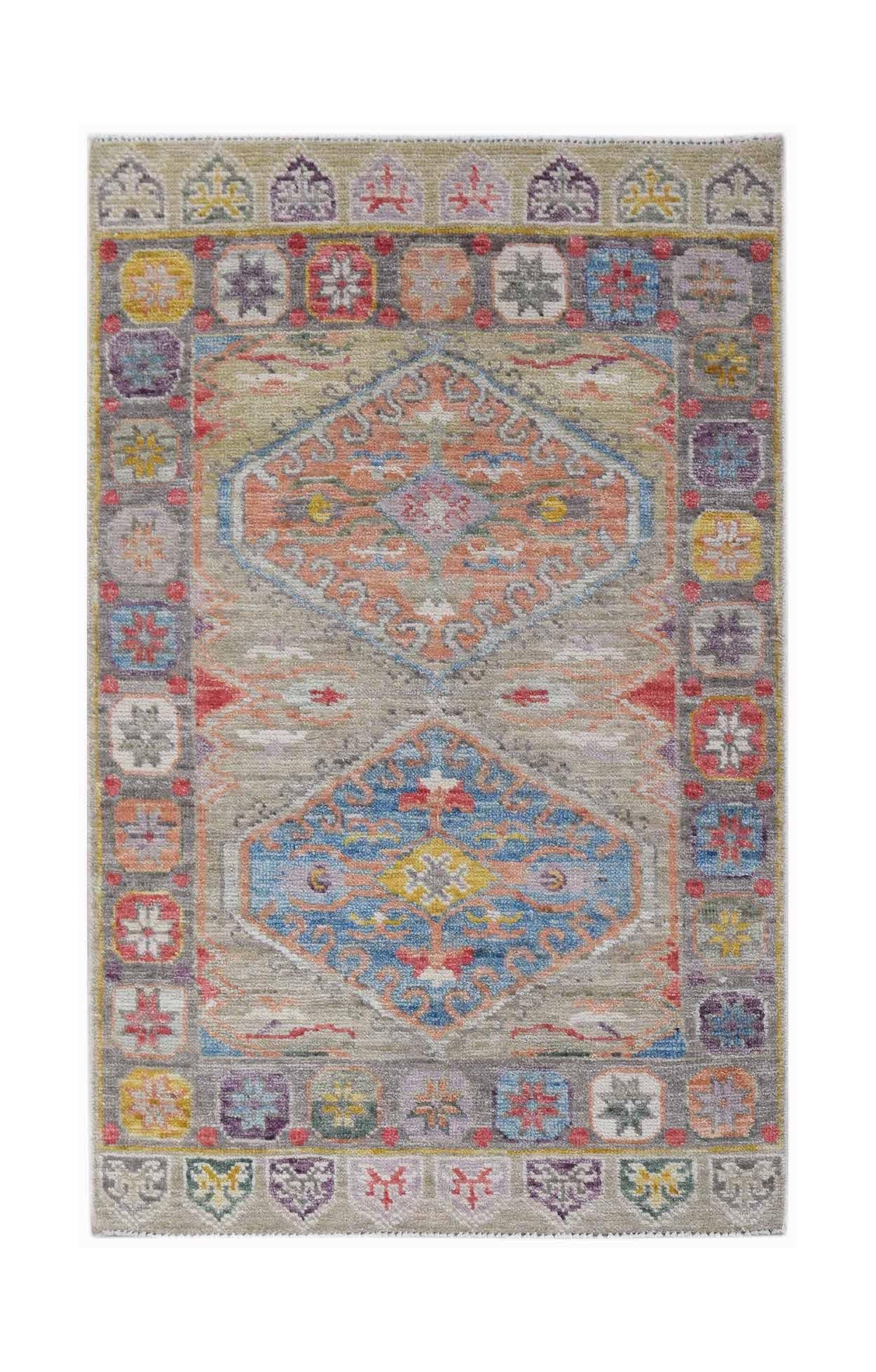 A handwoven transitional Oushak rug featuring two central medallions in a colorful floral pattern.